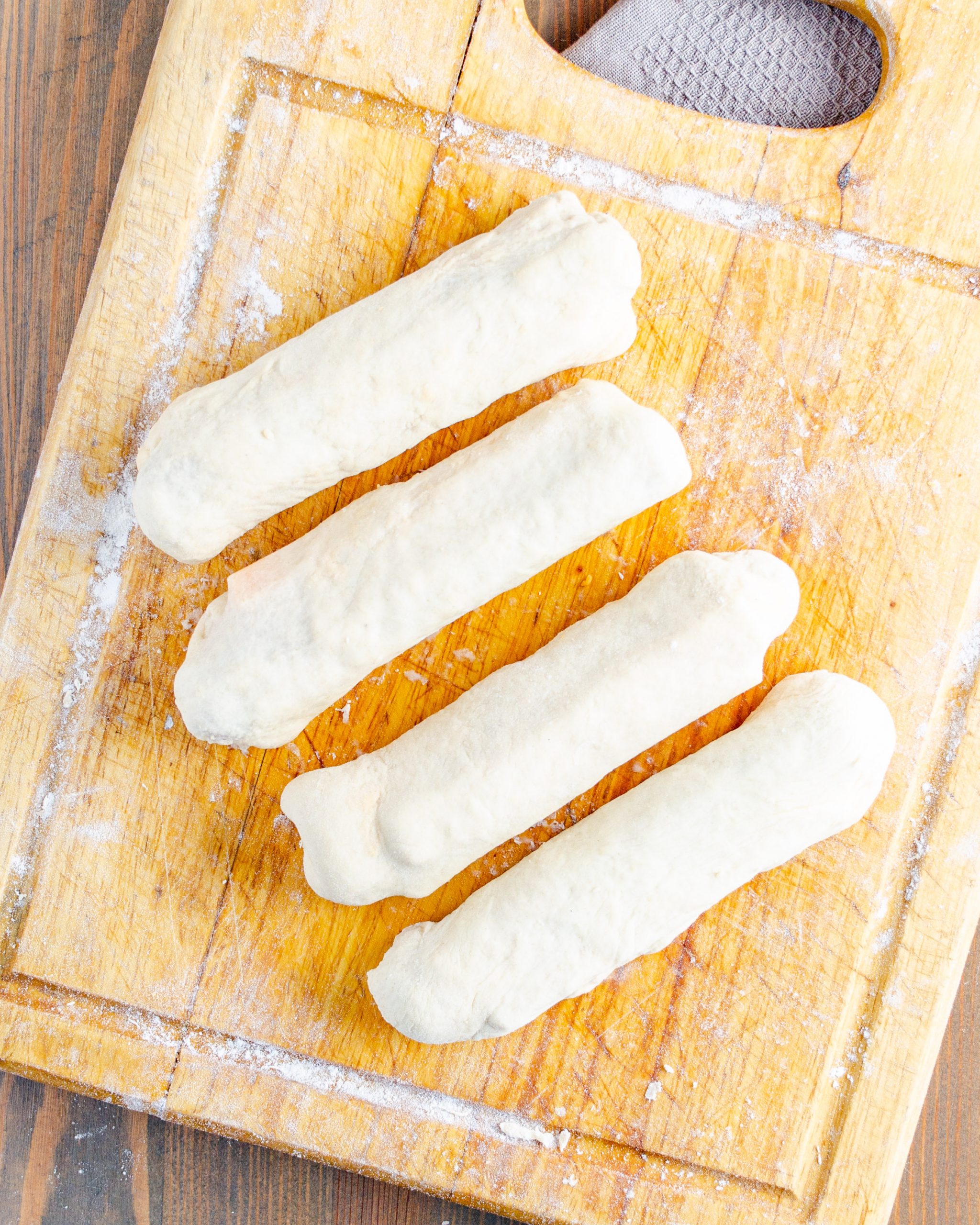Fold the ends of the dough up and then roll the dough around the hotdog and cheese stick in the center.
