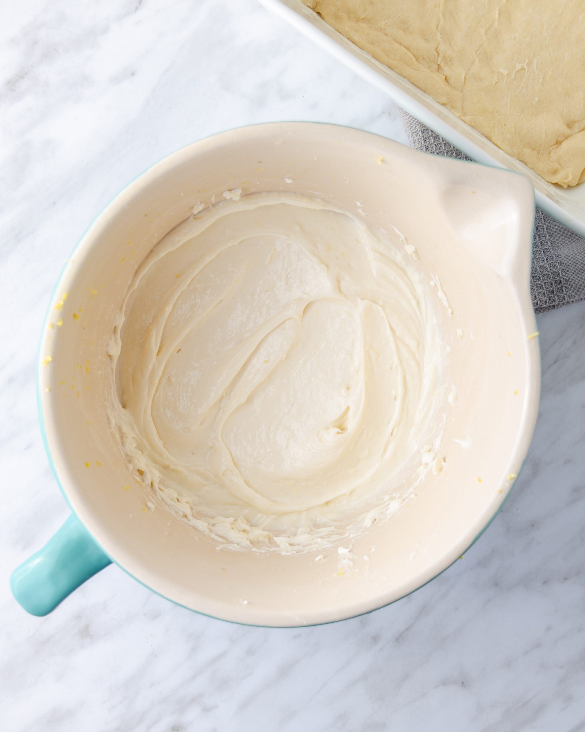 Combine the cream cheese, vanilla, lemon juice, lemon zest, and ½ cup of sugar in a mixing bowl until smooth.