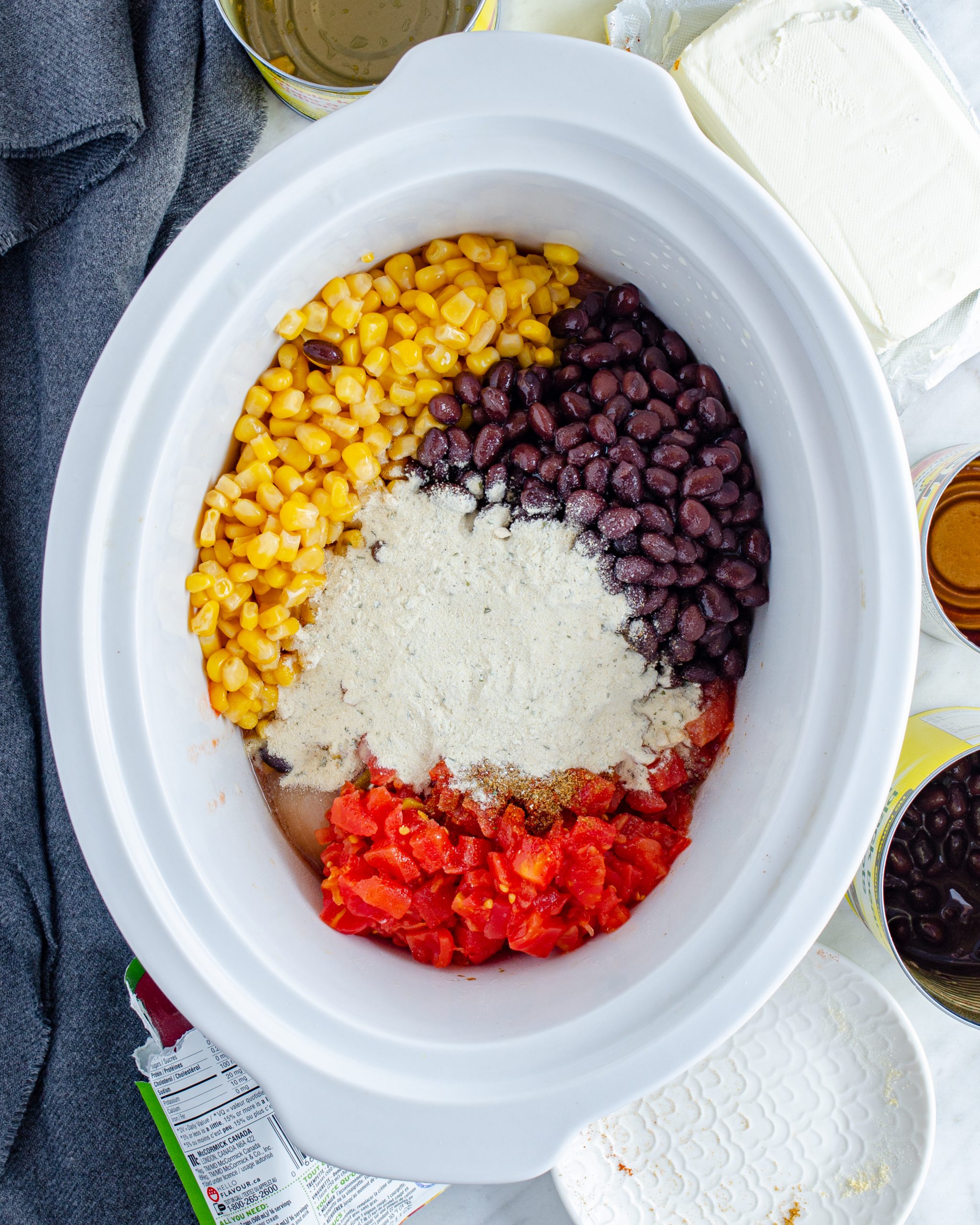 Pour the Rotel, corn, and beans over the chicken. 