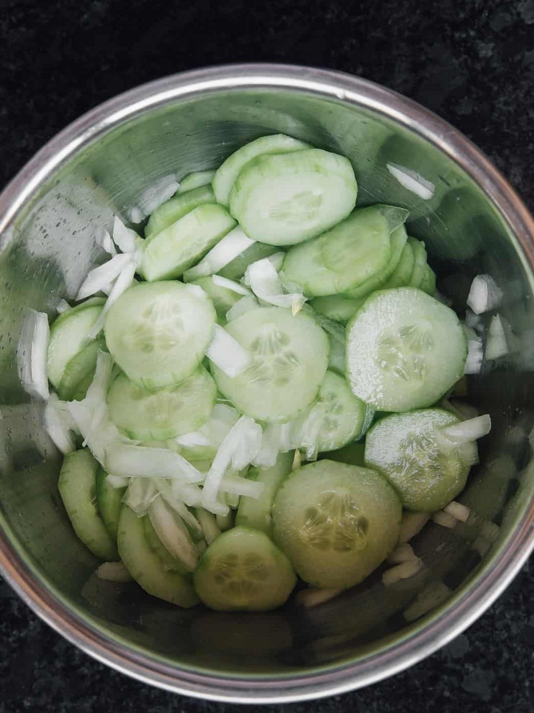 Mix cucumbers, sweet onion, and sea salt together in a bowl. Cover bowl with plastic wrap and let sit for 30 minutes.