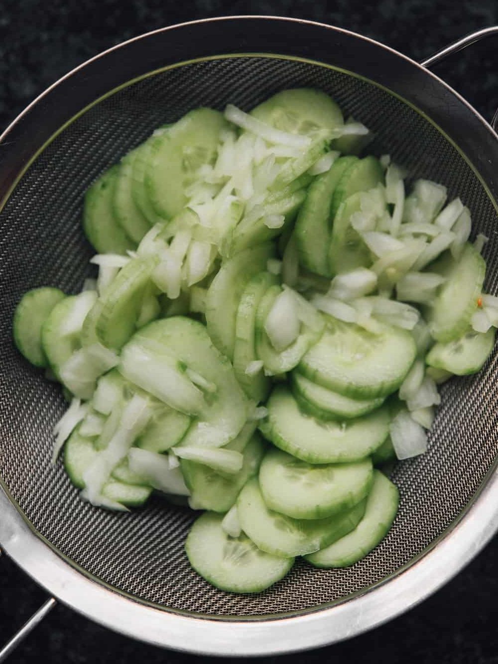 Turn cucumber mixture into a colander set over a bowl or in a sink; let drain, stirring occasionally, until most of the liquid has drained, about 30 minutes more. Transfer the drained cucumber mixture to a large bowl.