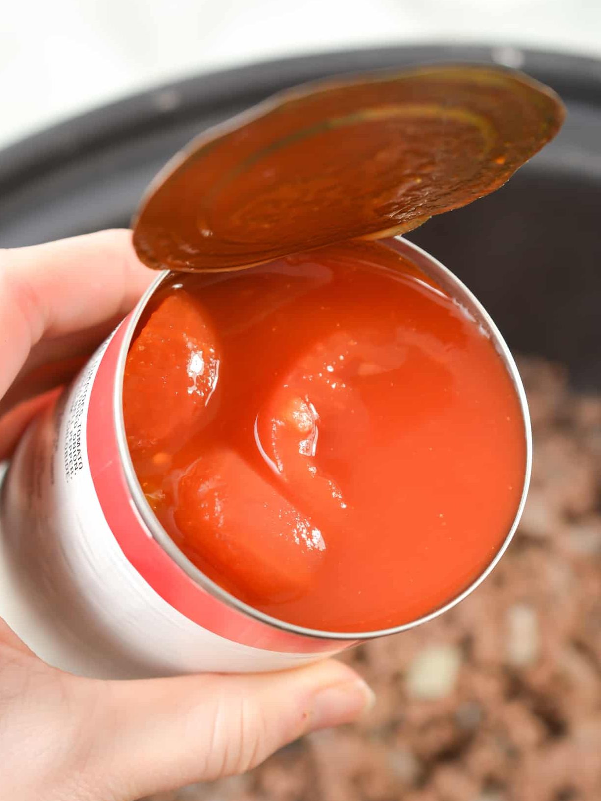 Cover the meat mixture with a 15 oz can of stewed tomatoes.