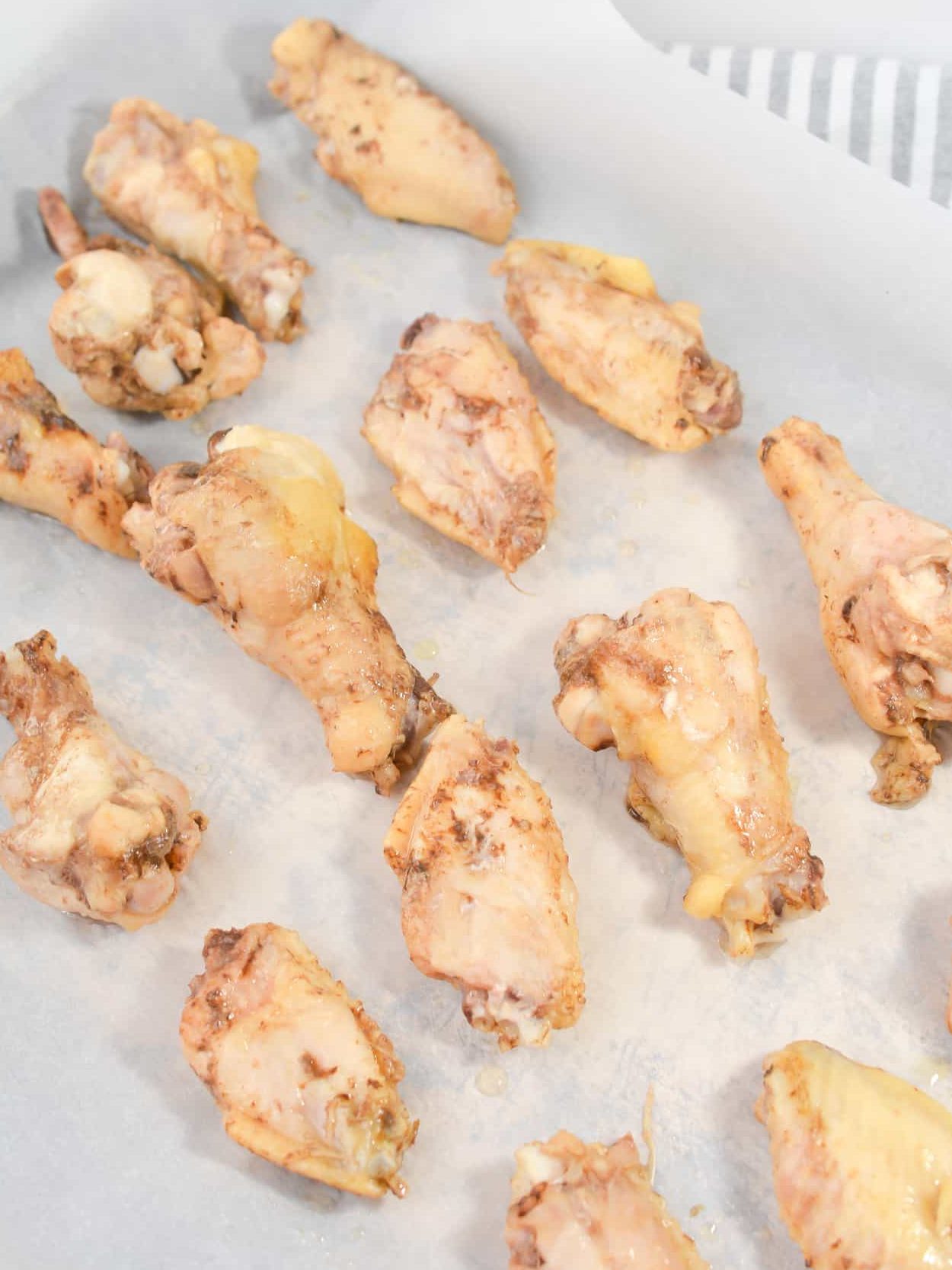Remove the chicken wings and place them onto a baking sheet.