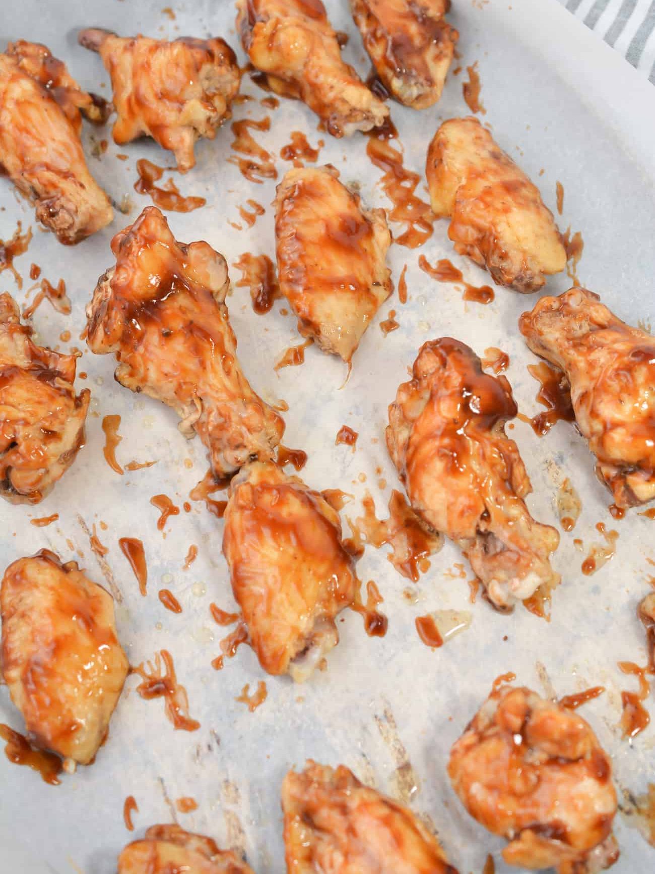 Brush the chicken wings with BBQ sauce on both sides.