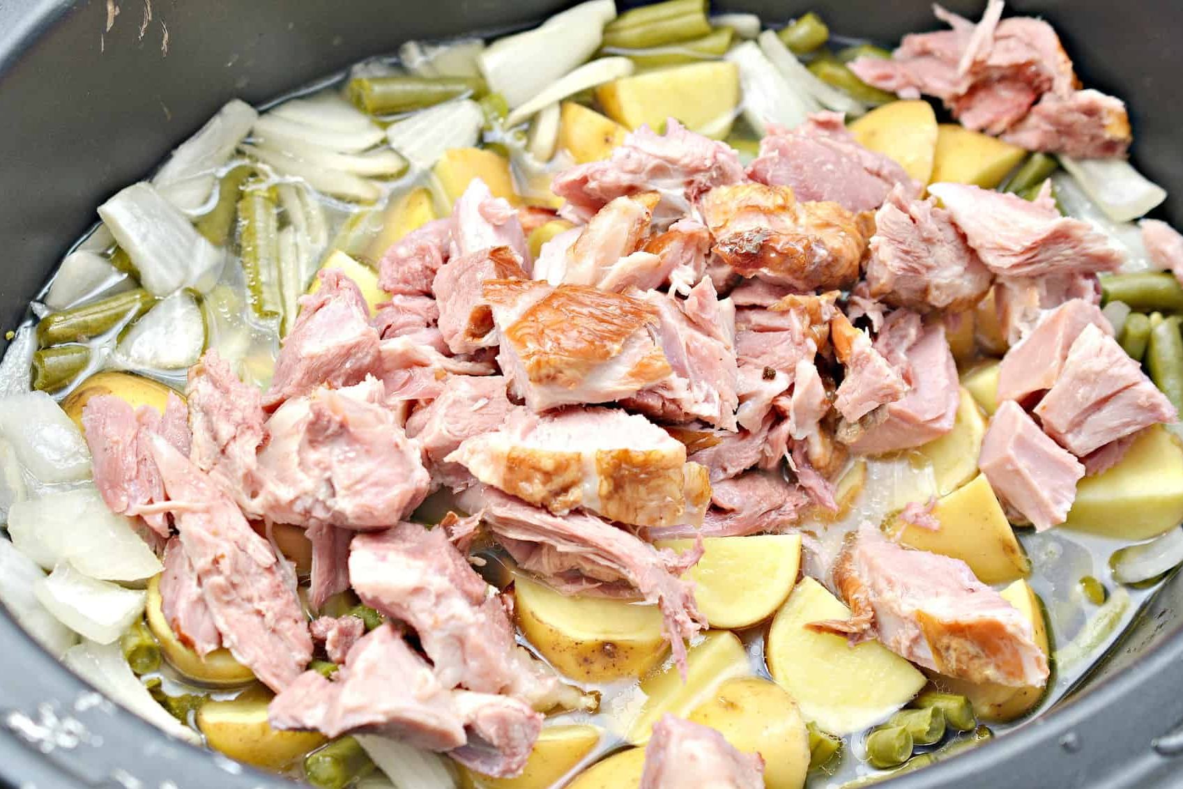 Slice and chop the ham before adding it back to the slow cooker.