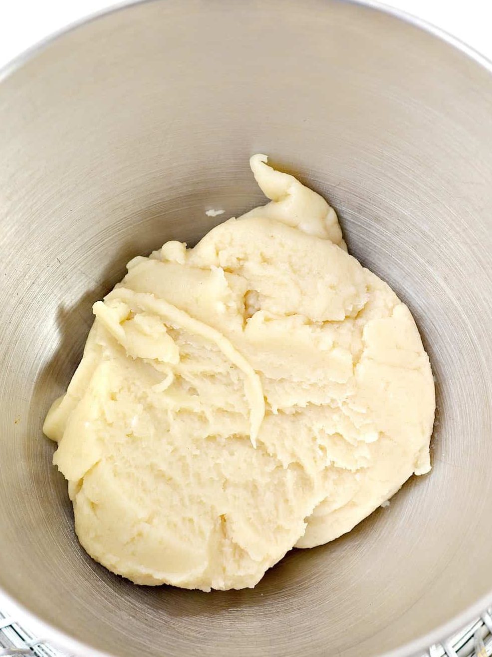 Add the dough to a mixing bowl, and beat on low until it has cooled down.
