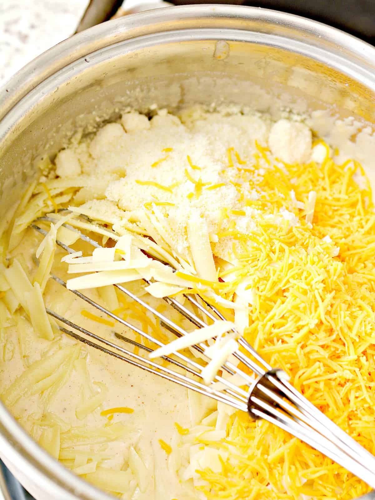 Whisk the cheeses into the sauce mixture until completely melted.
