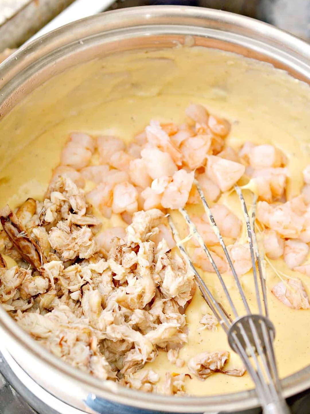 Stir the seafood into the cheese mixture, and cook until heated through.