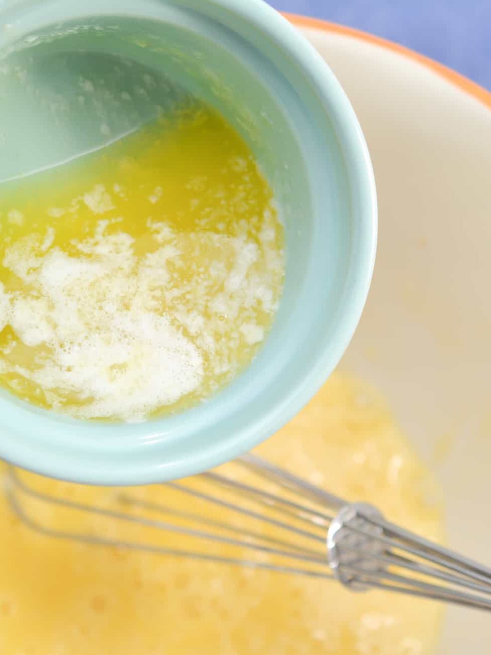In a mixing bowl, add 2 large eggs and 4 tbsp melted butter.