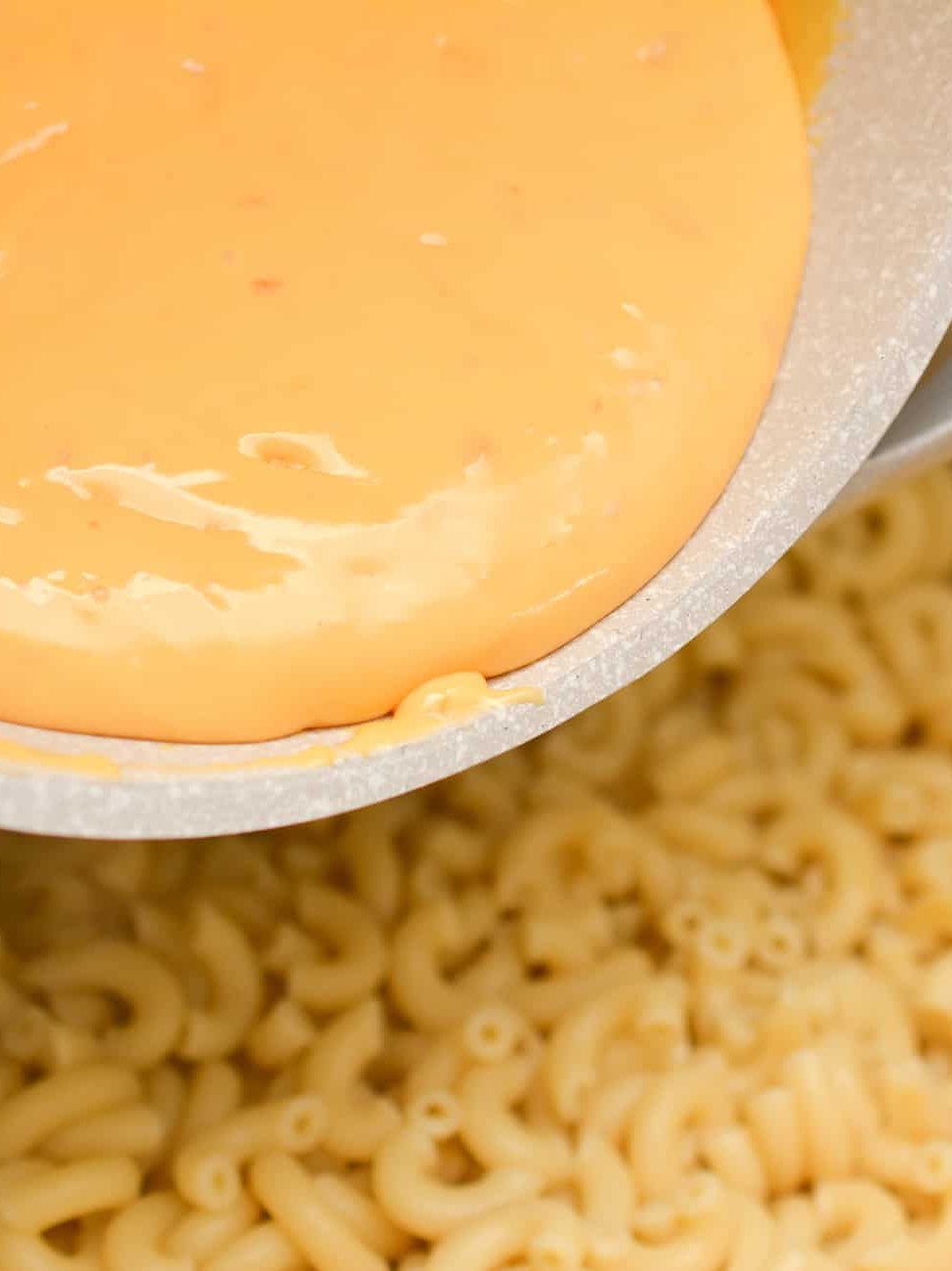 Pour the cheese sauce over the macaroni and stir to combine.