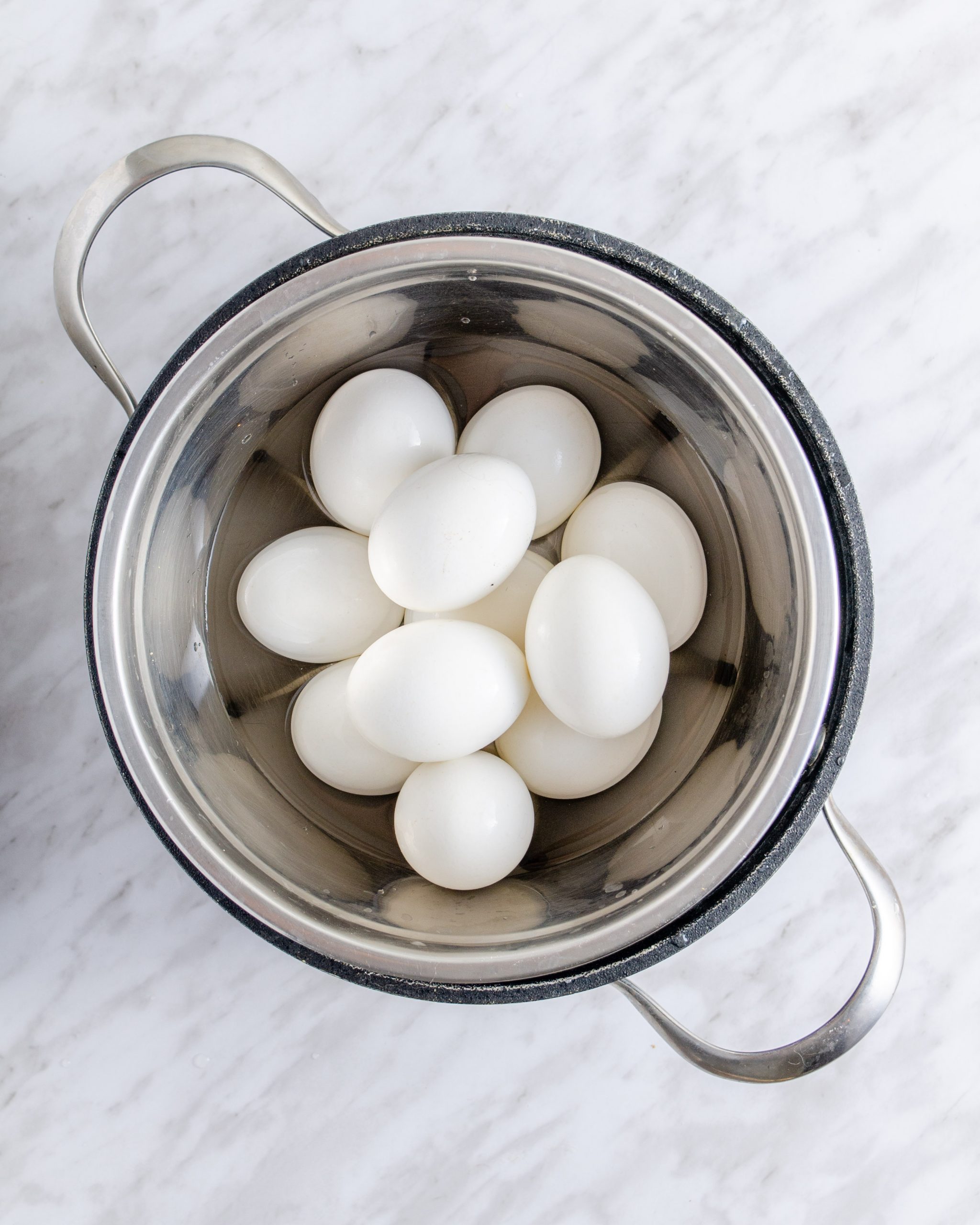 Place a trivet into the instant pot and pile your eggs onto the trivet