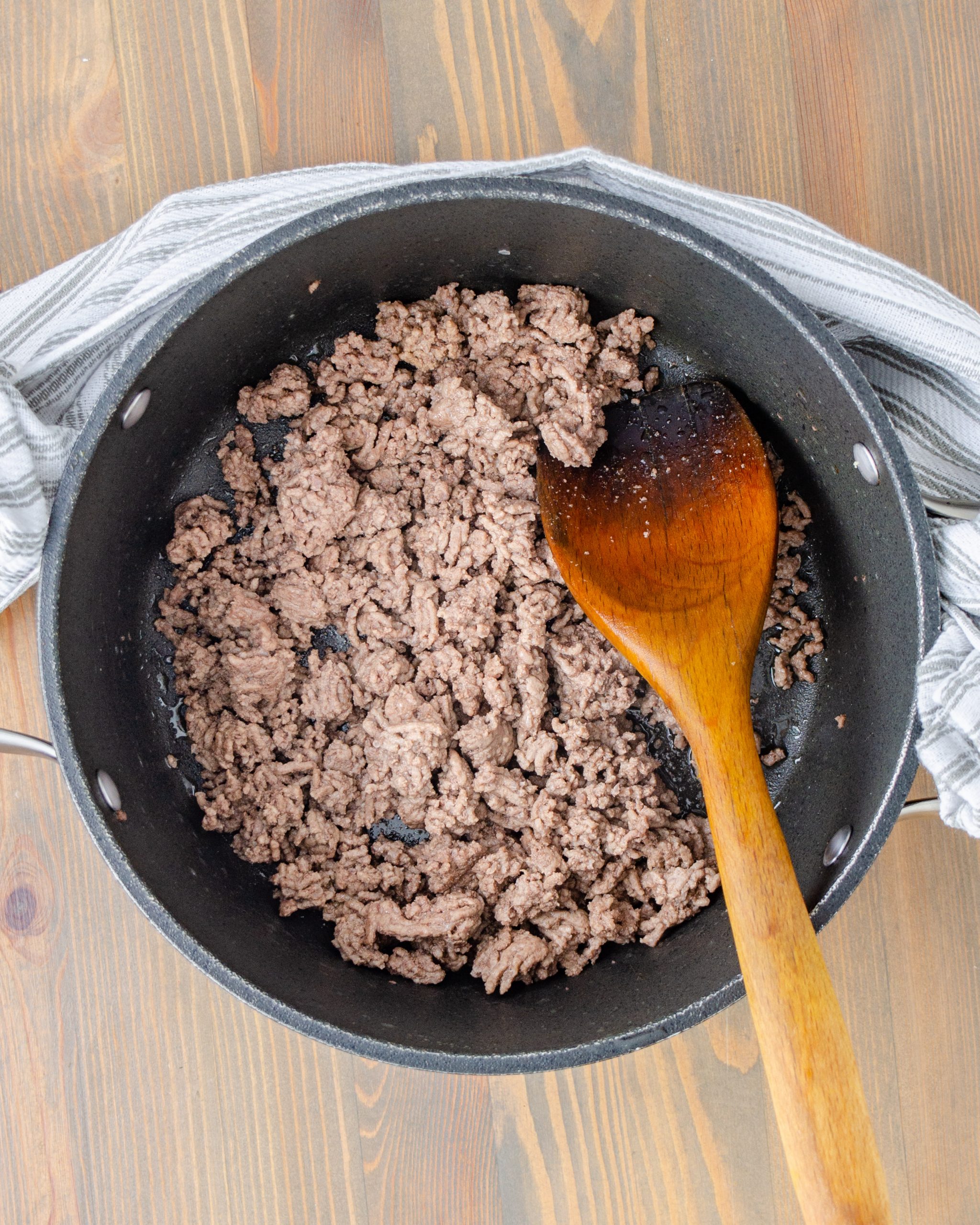 Brown the meat completely in a large pot, and drain any excess fat.