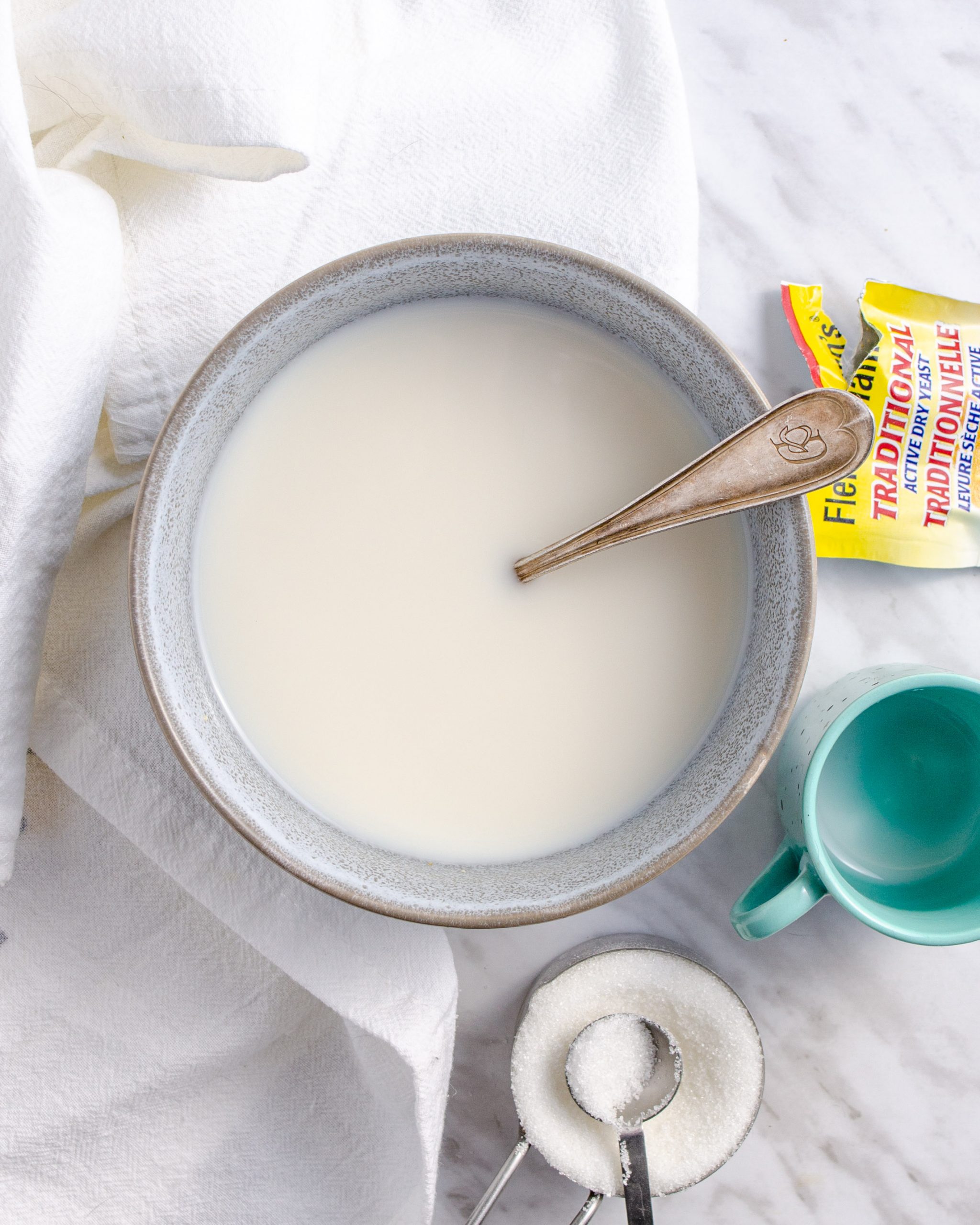 Place the boiling water, 1 tsp. Sugar, yeast, and milk into a bowl, stir and allow to sit for 10 minutes untouched.