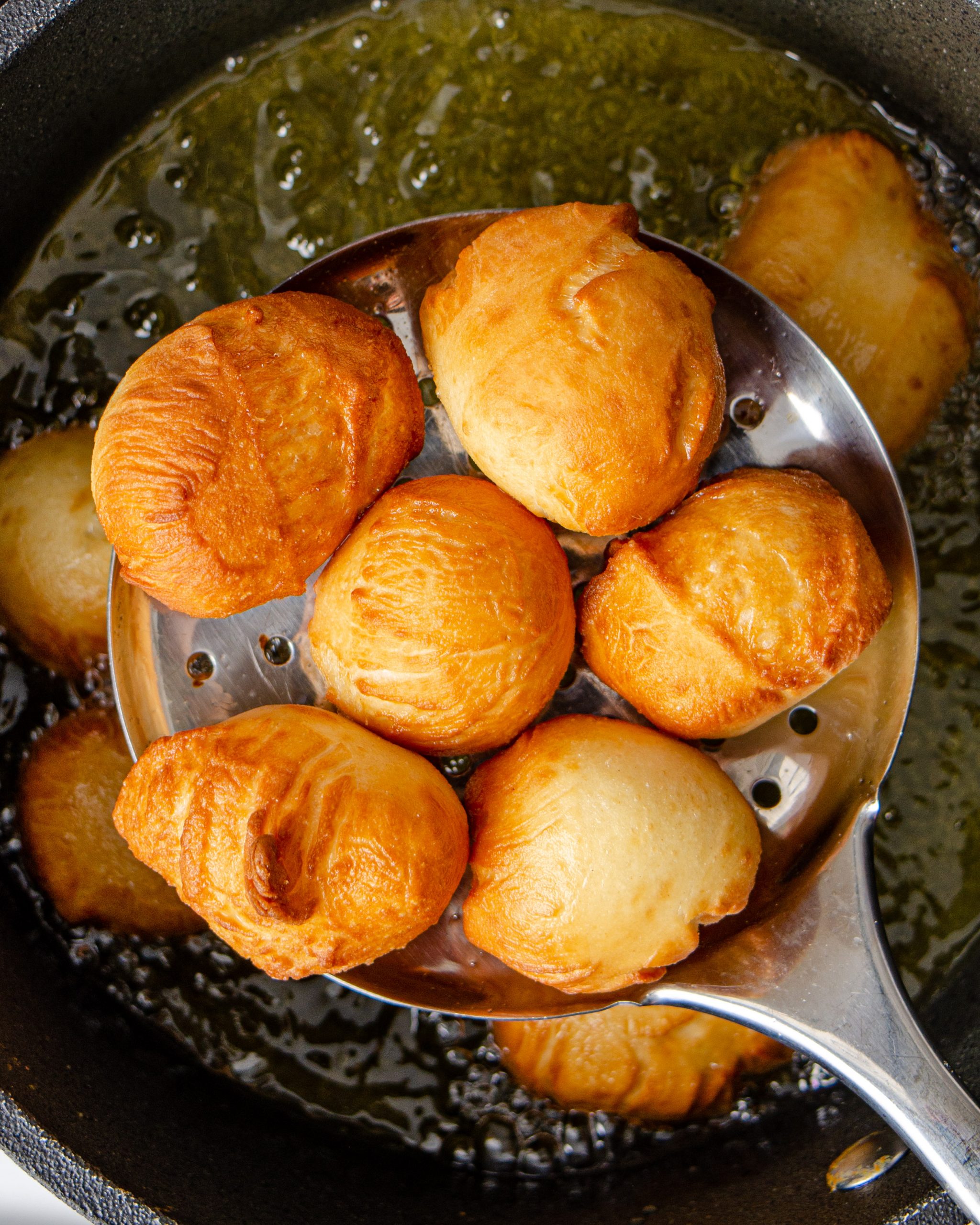 Cook the balls of dough for a few minutes in the oil until golden brown.