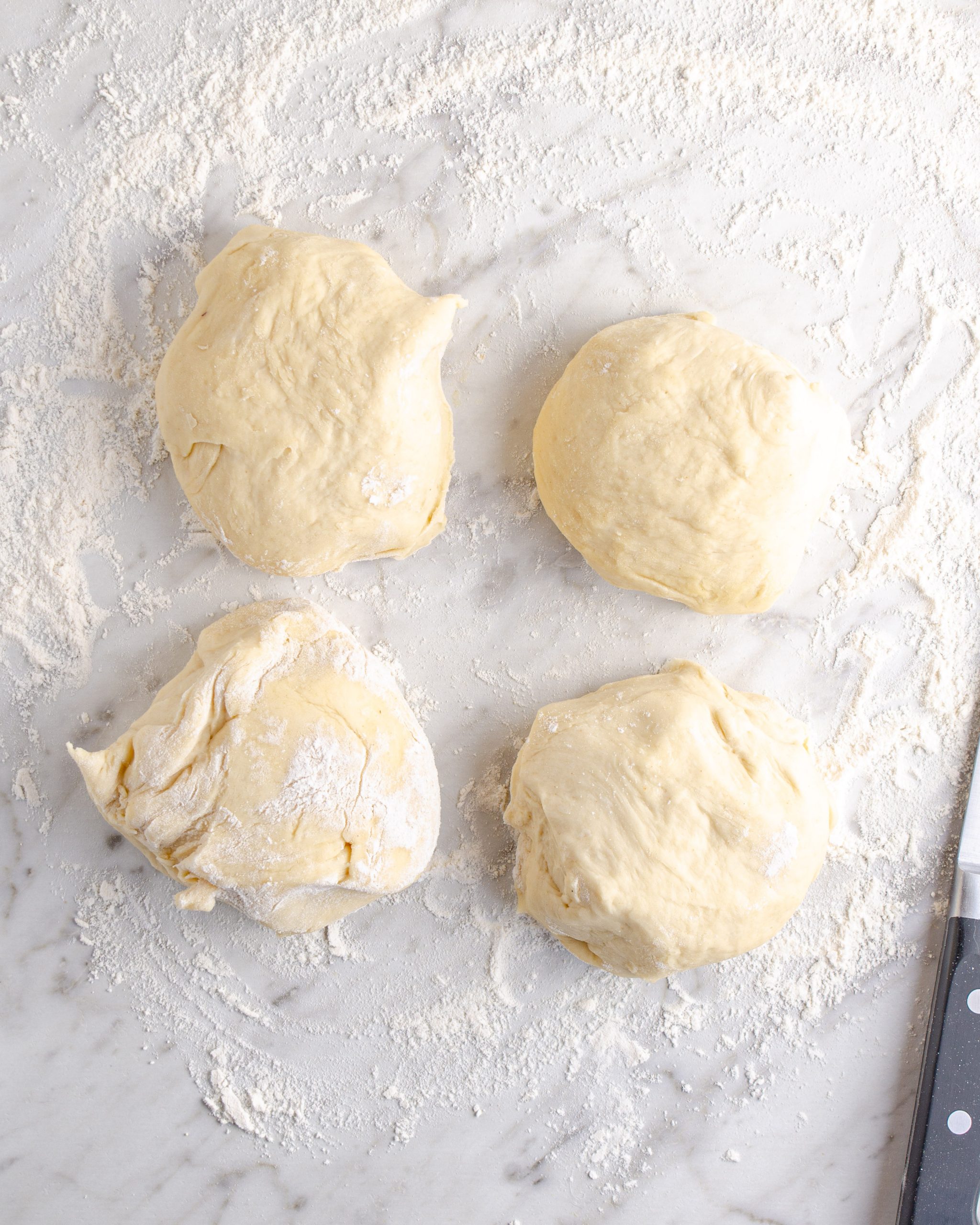 Make four even sections with the dough, and roll each section into a log shape on a floured surface. Each log of dough should be no more than 2 inches wide.