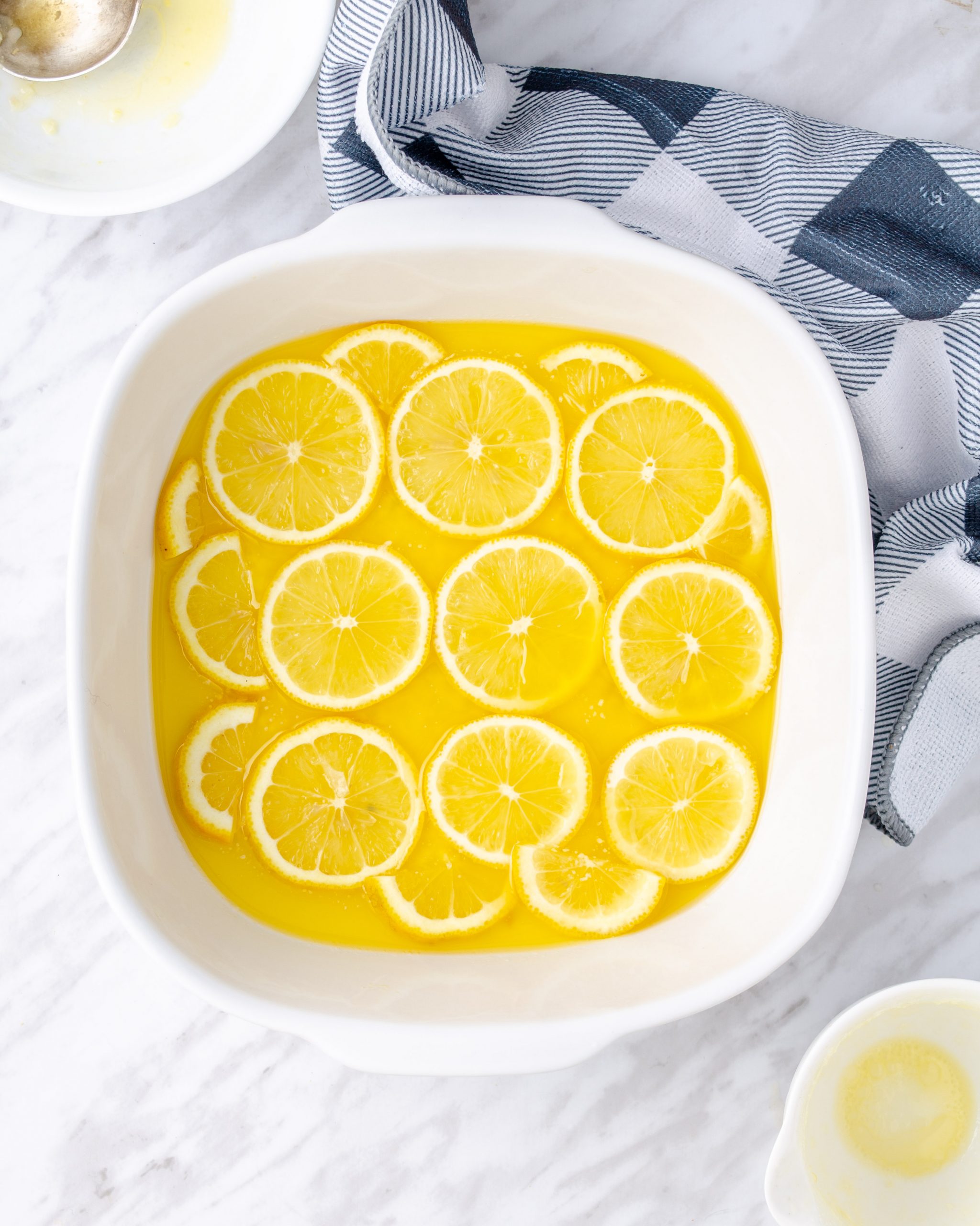 Arrange the lemon slices on top of the butter, forming a single layer.