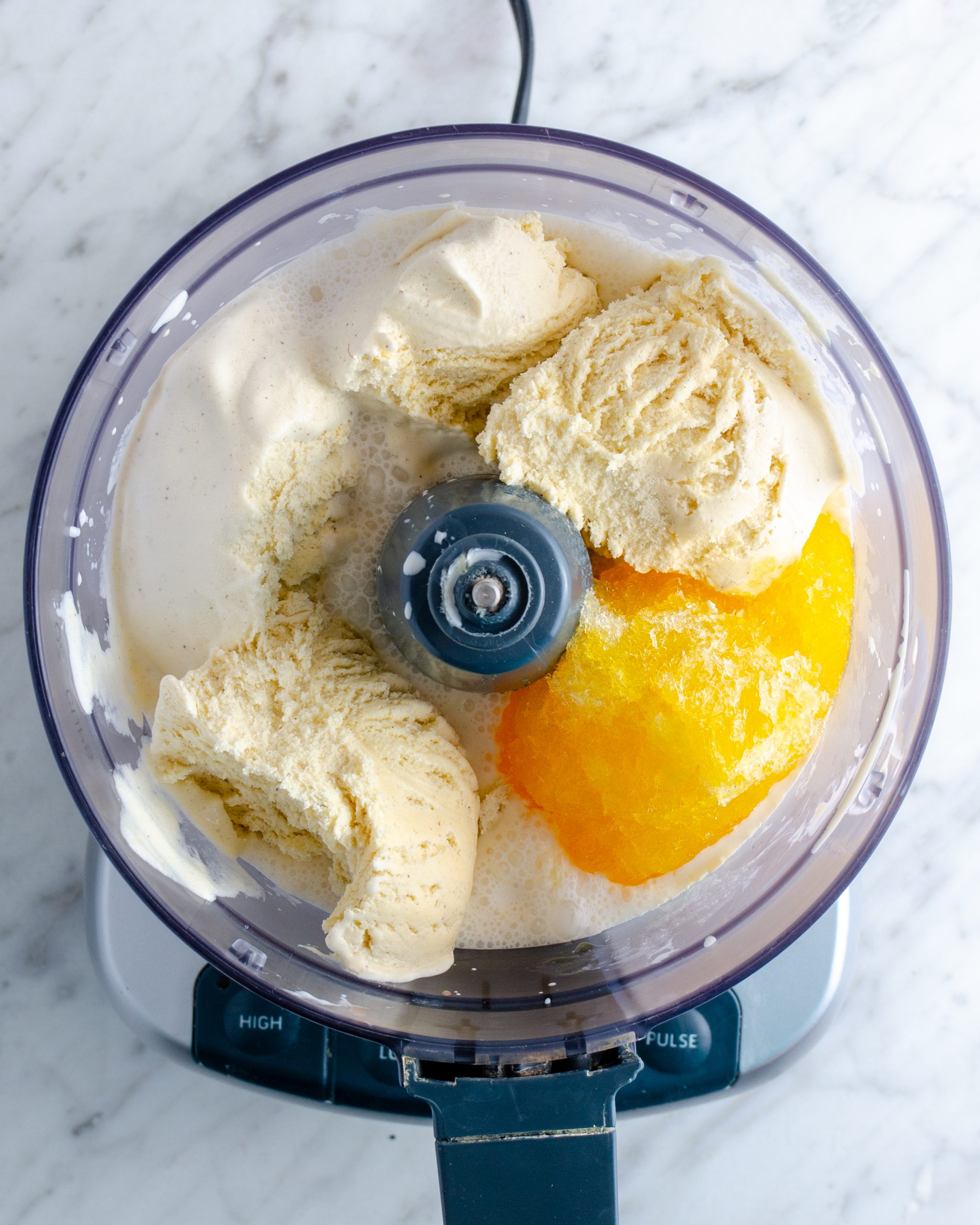 Place the ice cream and orange juice concentrate into the blender or food processor.
