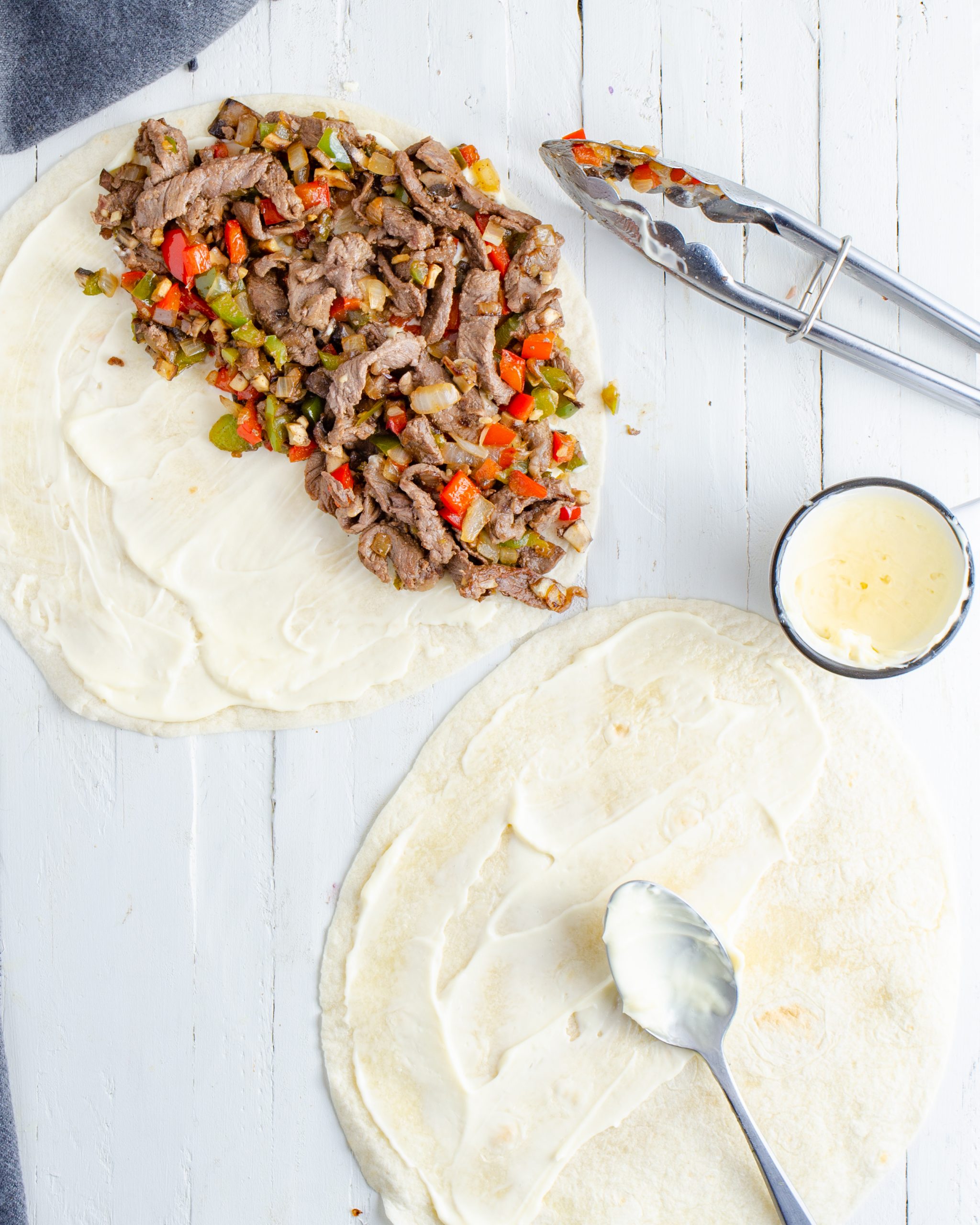 Layer the mayonnaise on the tortillas, and then place the filling mixture on one side of each tortilla. 