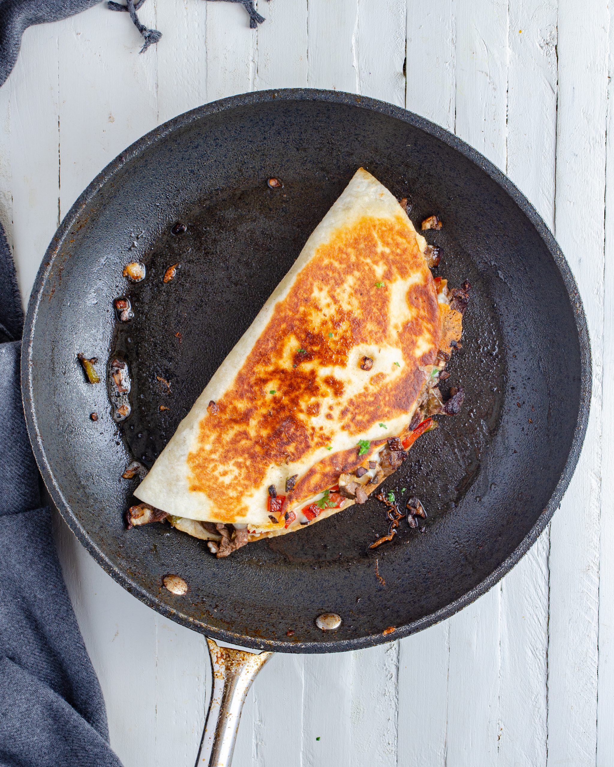 Add a tsp of olive oil to a skillet, and lightly brown the folded tortillas evenly on both sides until crispy and until the cheese has melted. 
