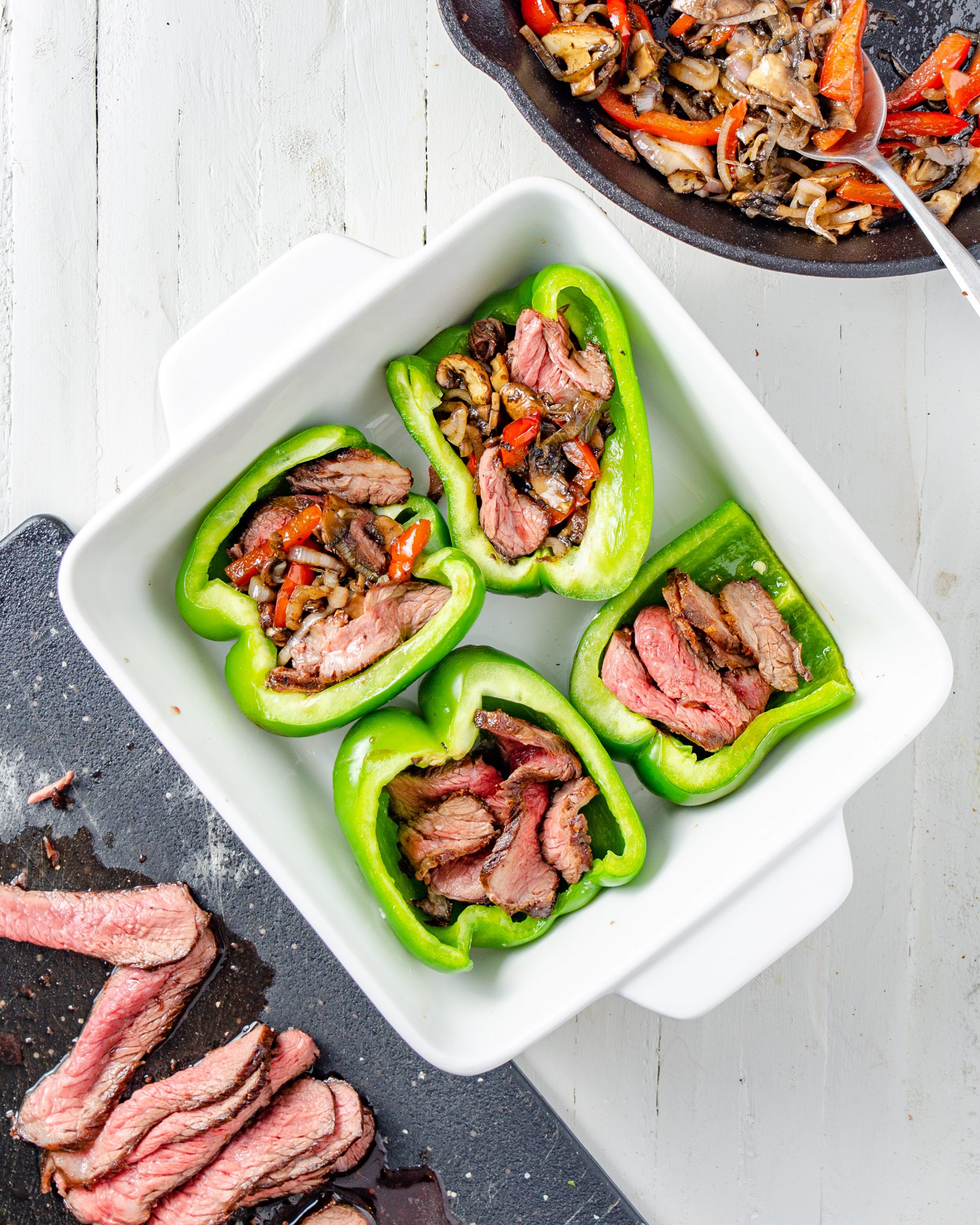 Take the green peppers out of the oven, and fill them with the steak and vegetable mixture. 