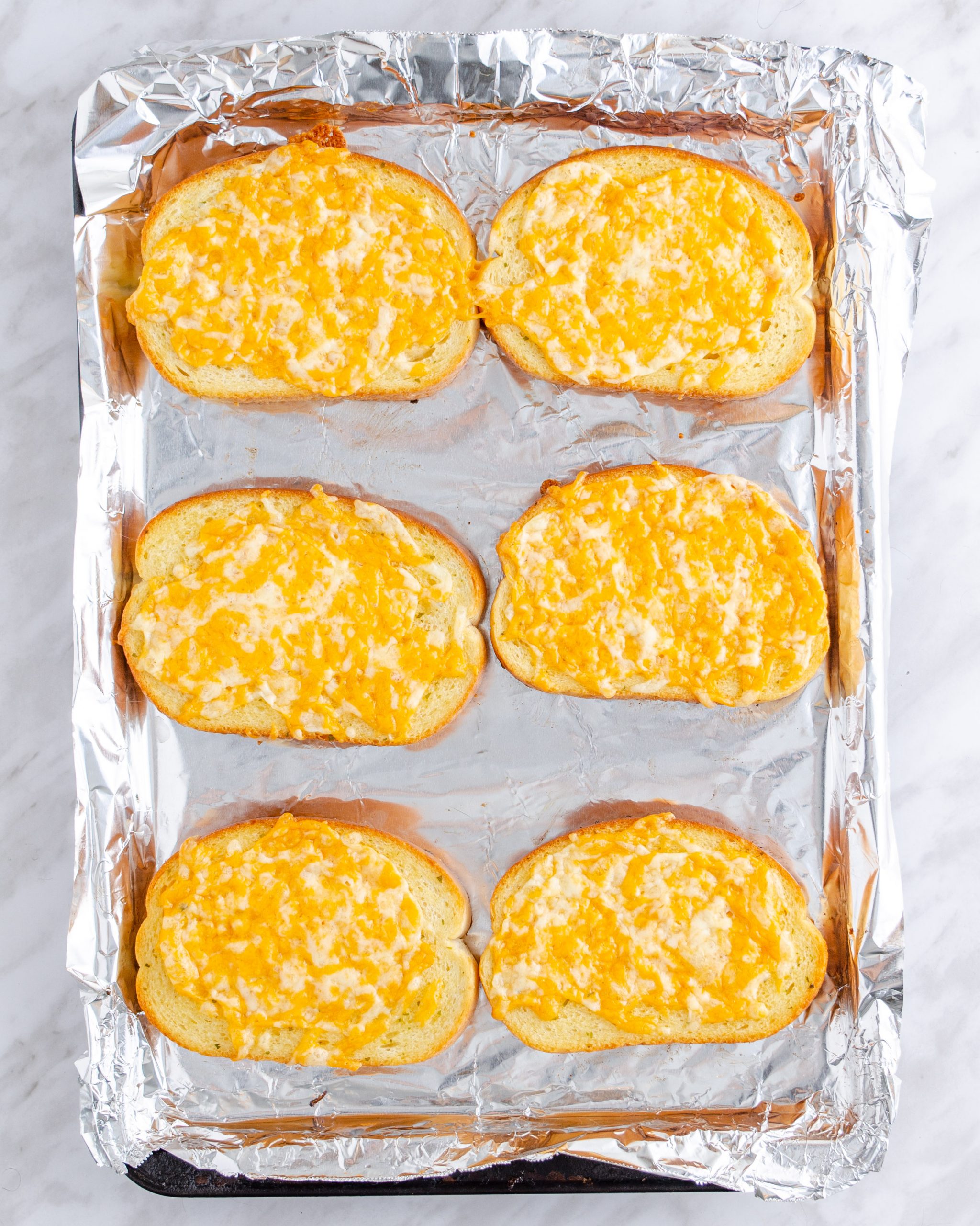 Bake the garlic cheese bread according to package instructions and let cool.