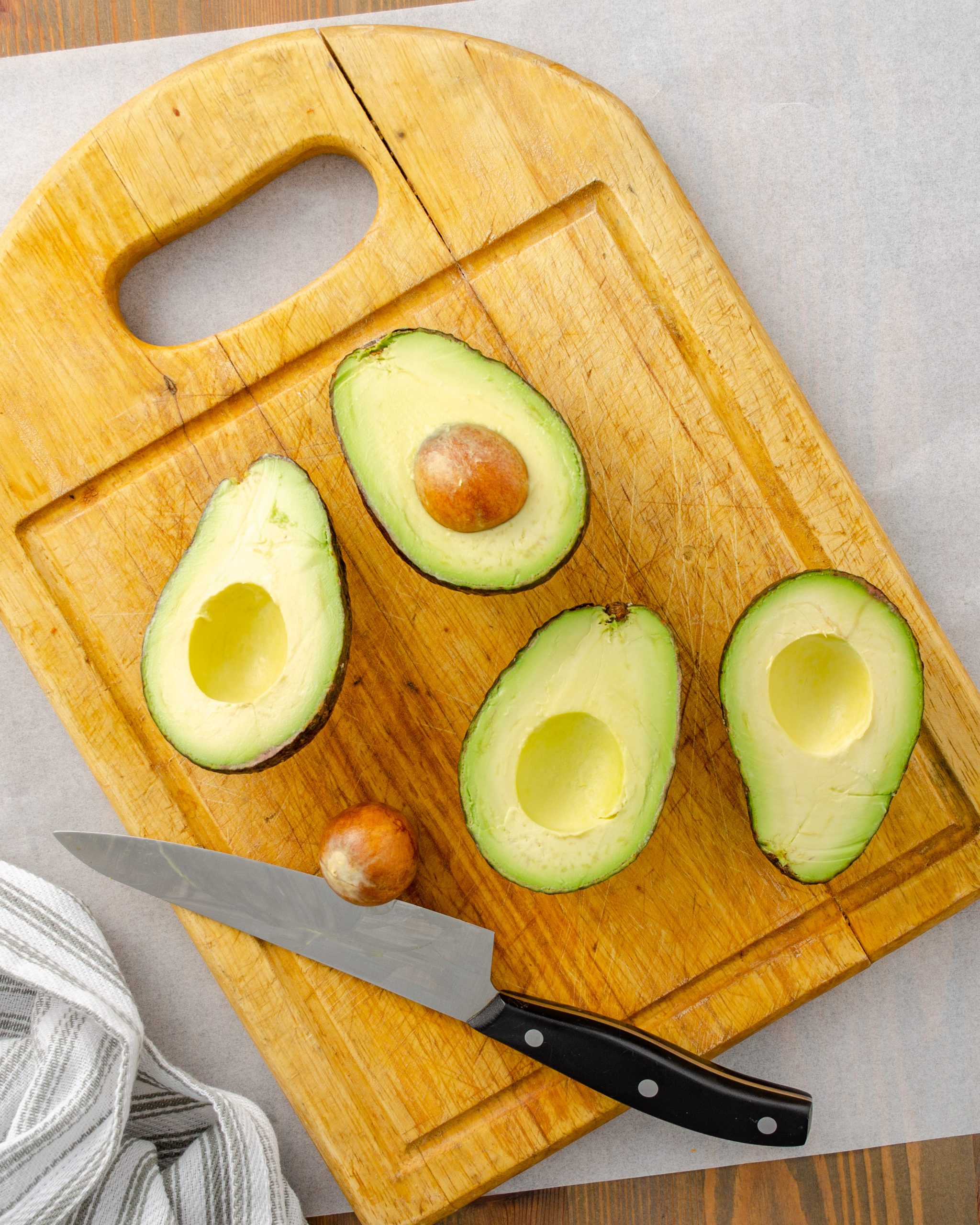Cut the avocados in half lengthwise and remove the pit.