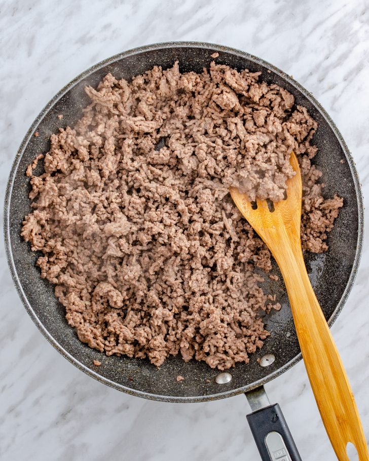Add the ground beef to a skillet over medium-high heat, and saute until completely browned. Drain and excess fat.