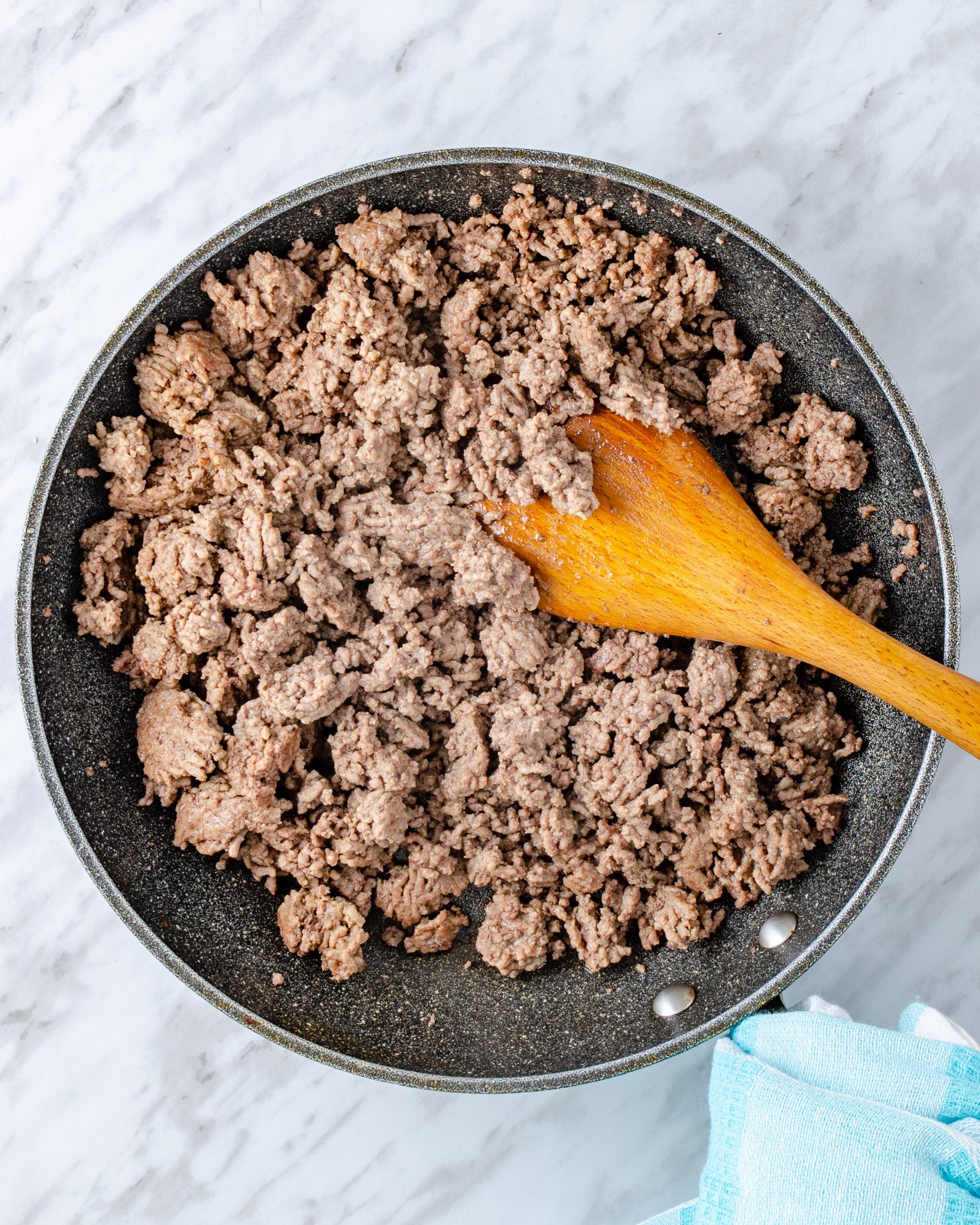 Add the ground beef to a large skillet over medium-high heat on the stove, and saute until the meat is completely browned. Drain any excess fat.