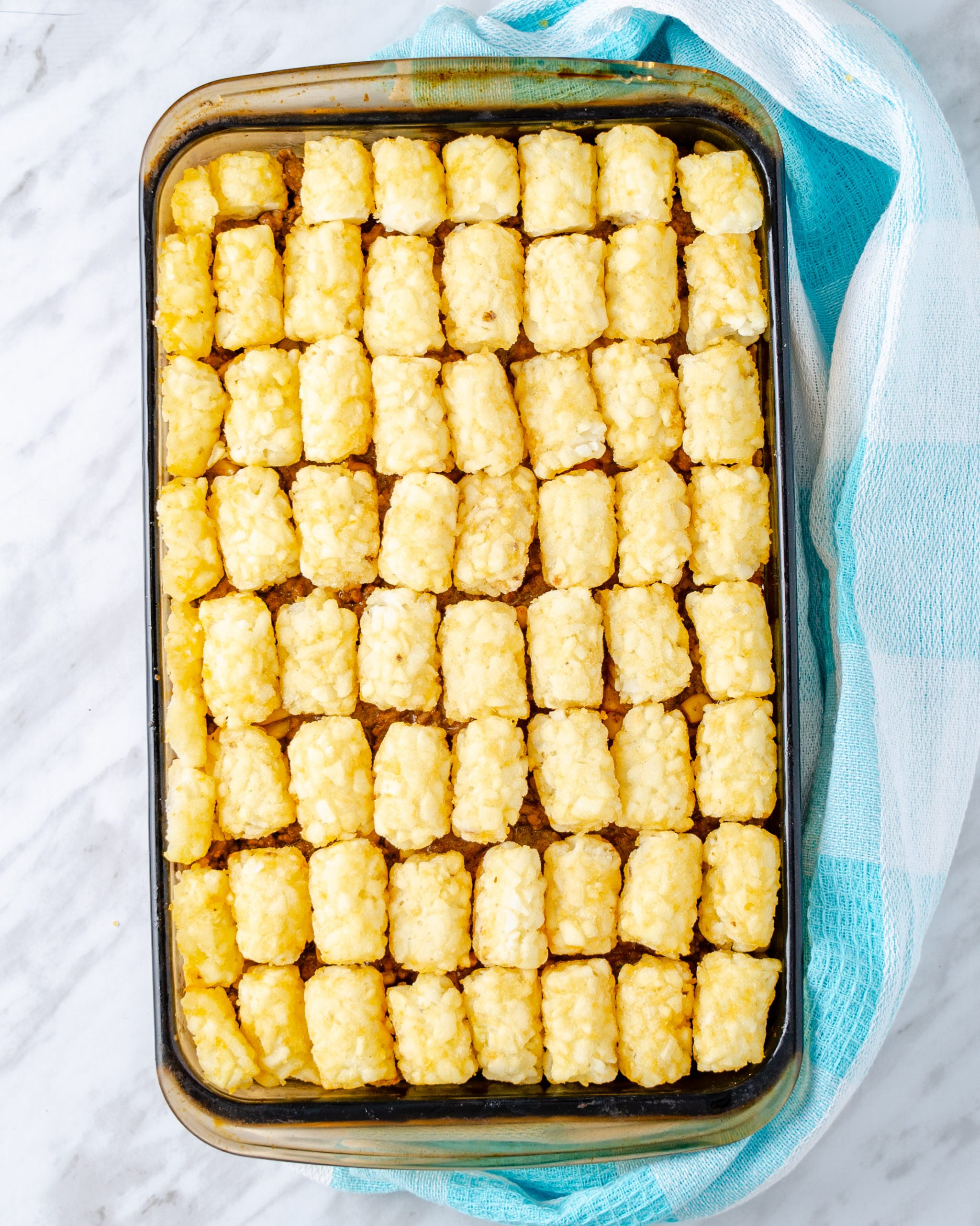Top the mixture with the tater tots in an even layer.