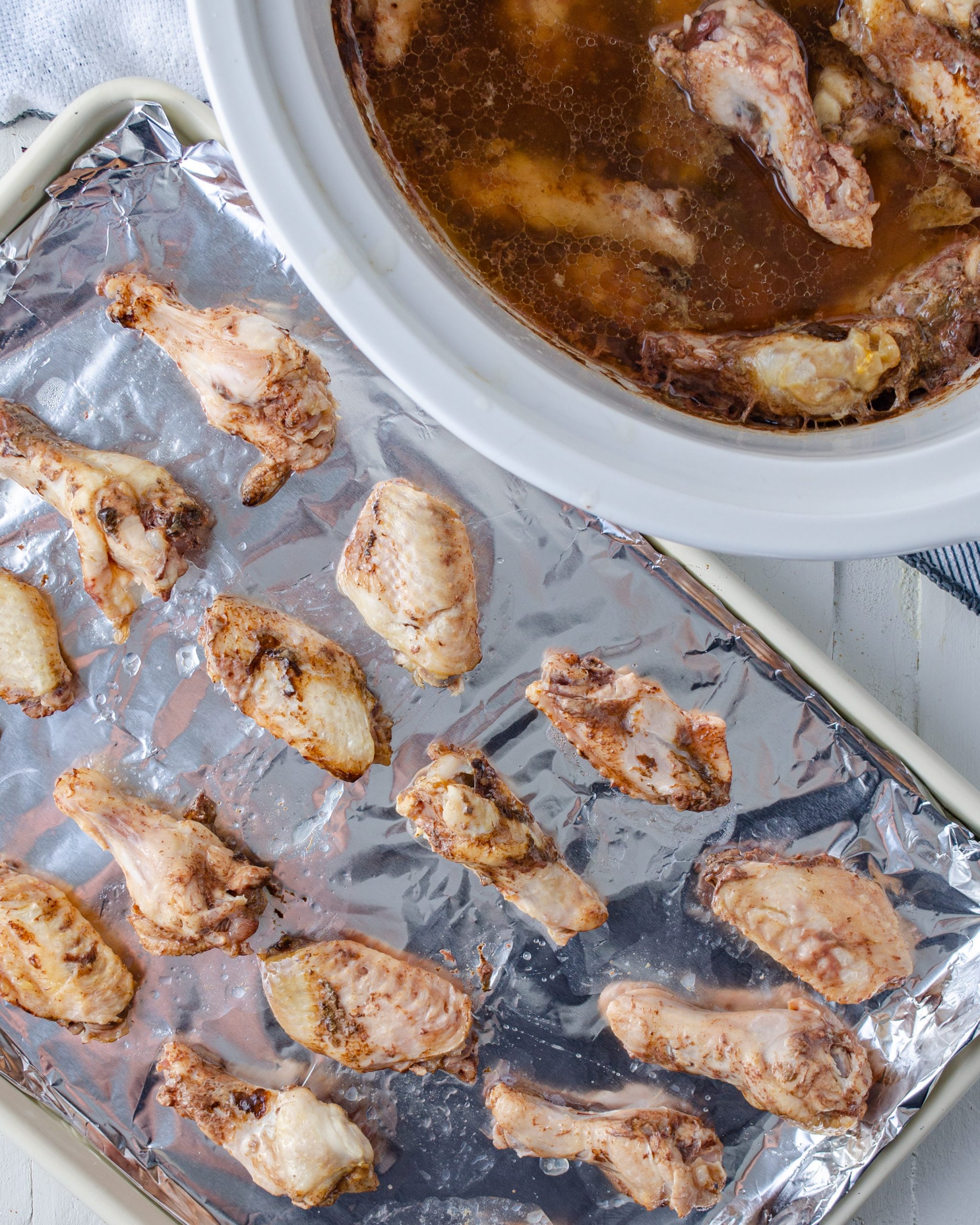 When finished in the slow cooker, place the wings onto an aluminum foil-lined baking sheet. 