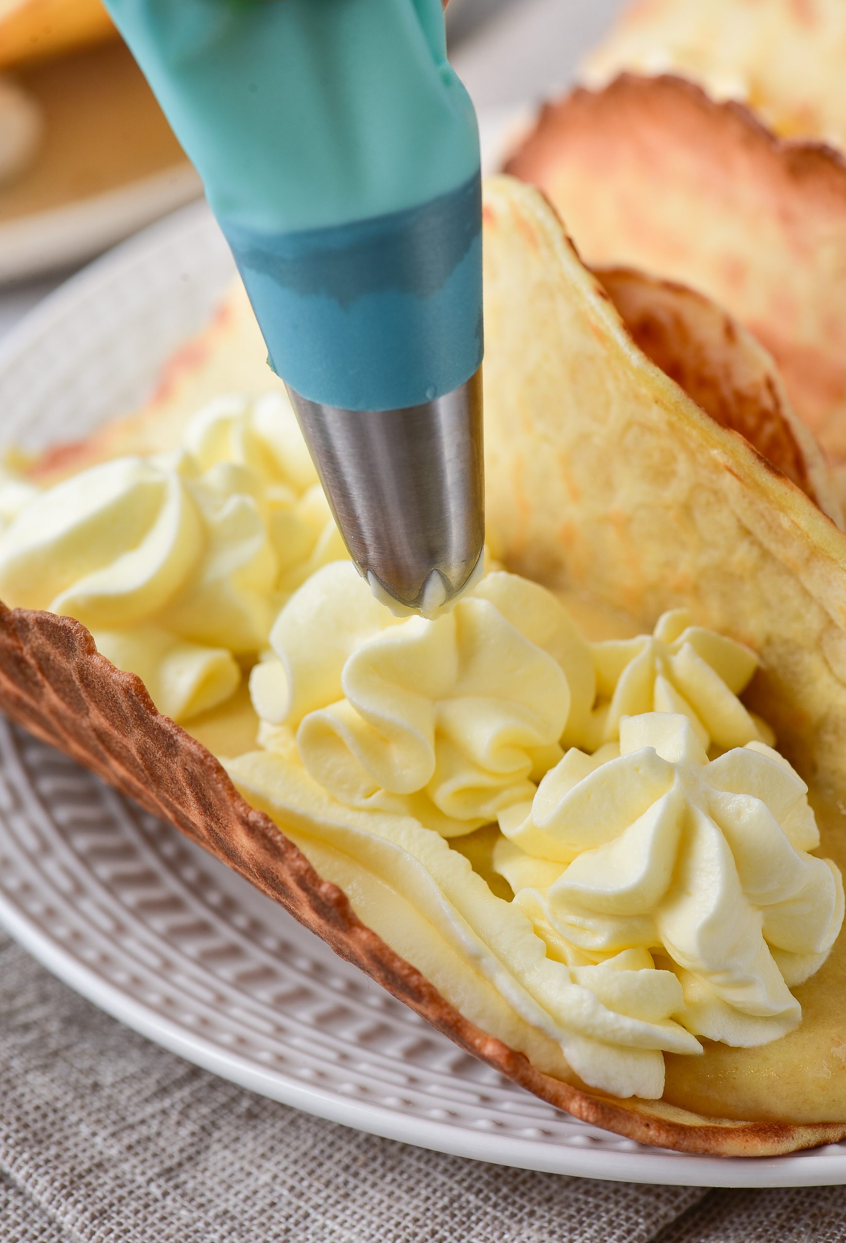 Spread an equal amount of the whipped topping onto each taco.