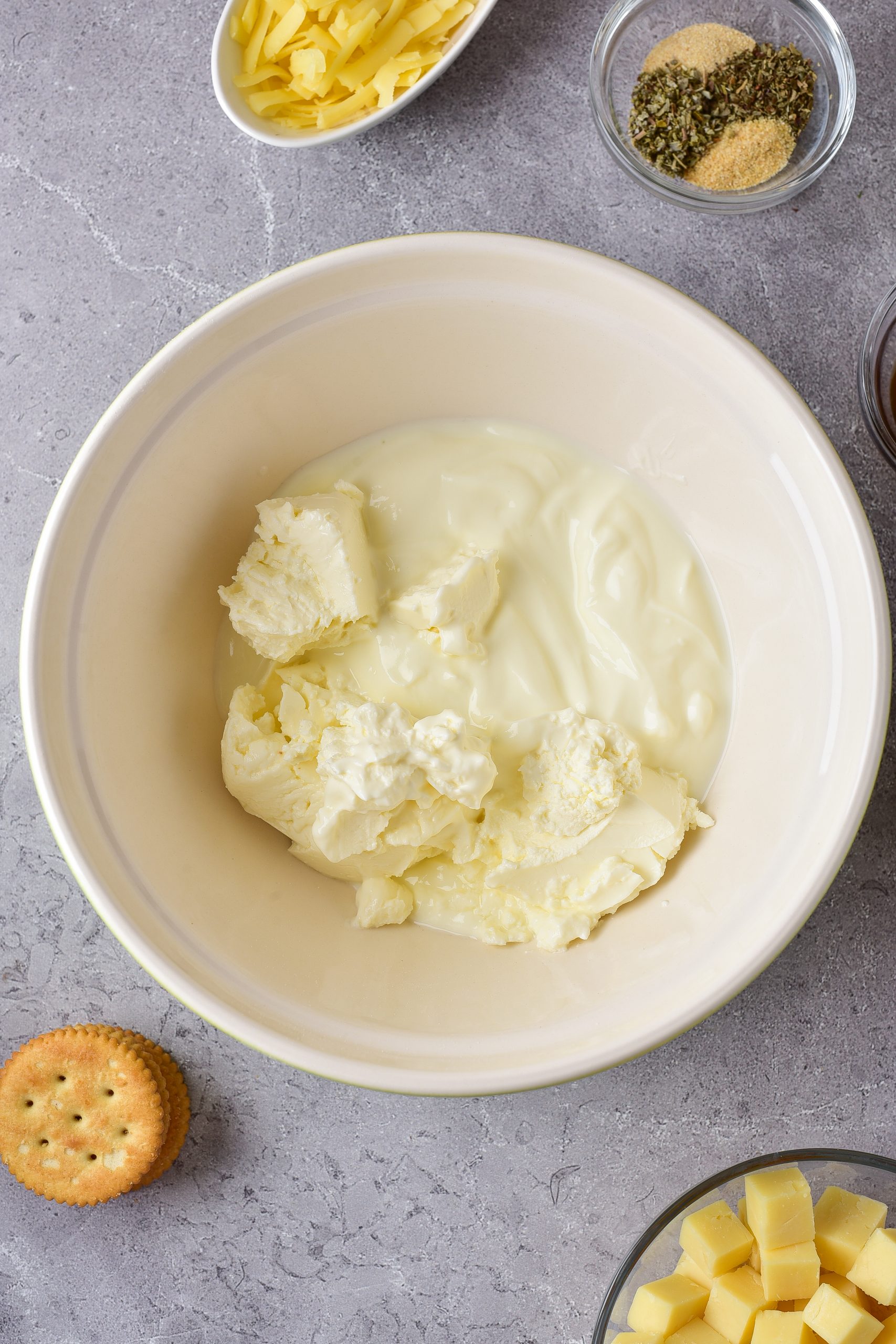 In a bowl, beat together the sour cream, and cream cheese.