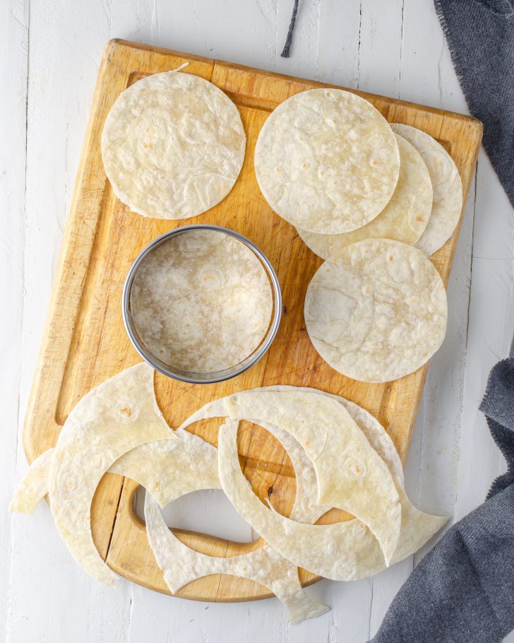Use a cookie cutter that is 4 inches around, and cut circles from the tortillas. 