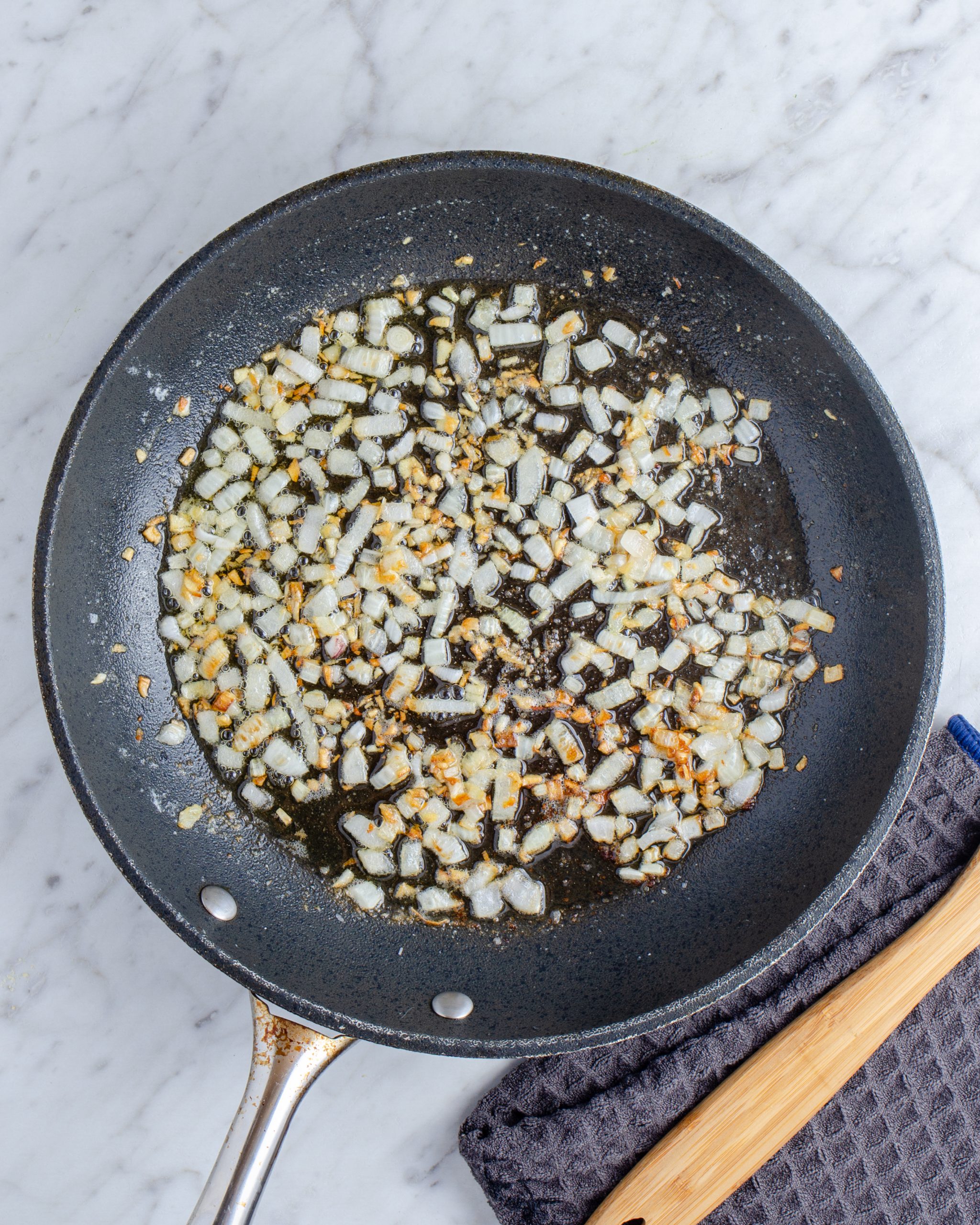 Add the butter to a deep-sided skillet over medium heat, and saute the onions until softened.