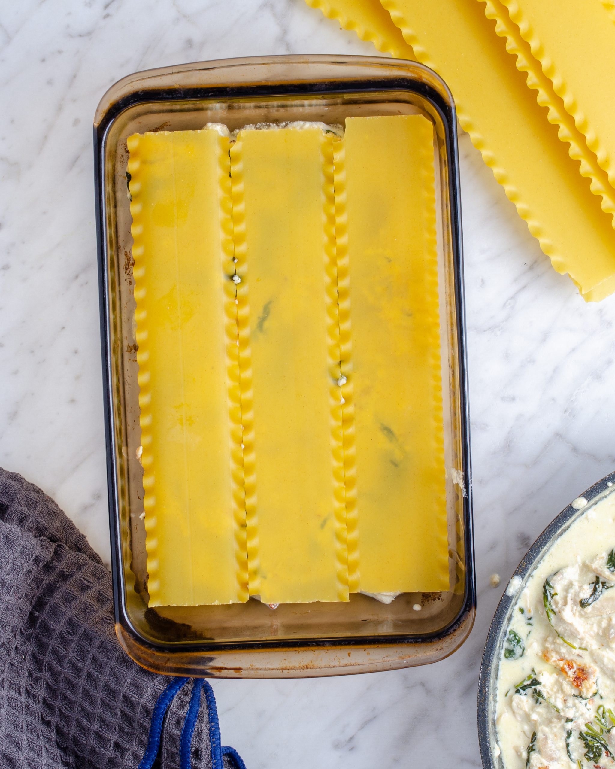 Add a layer of lasagna noodles on top of the sauce.