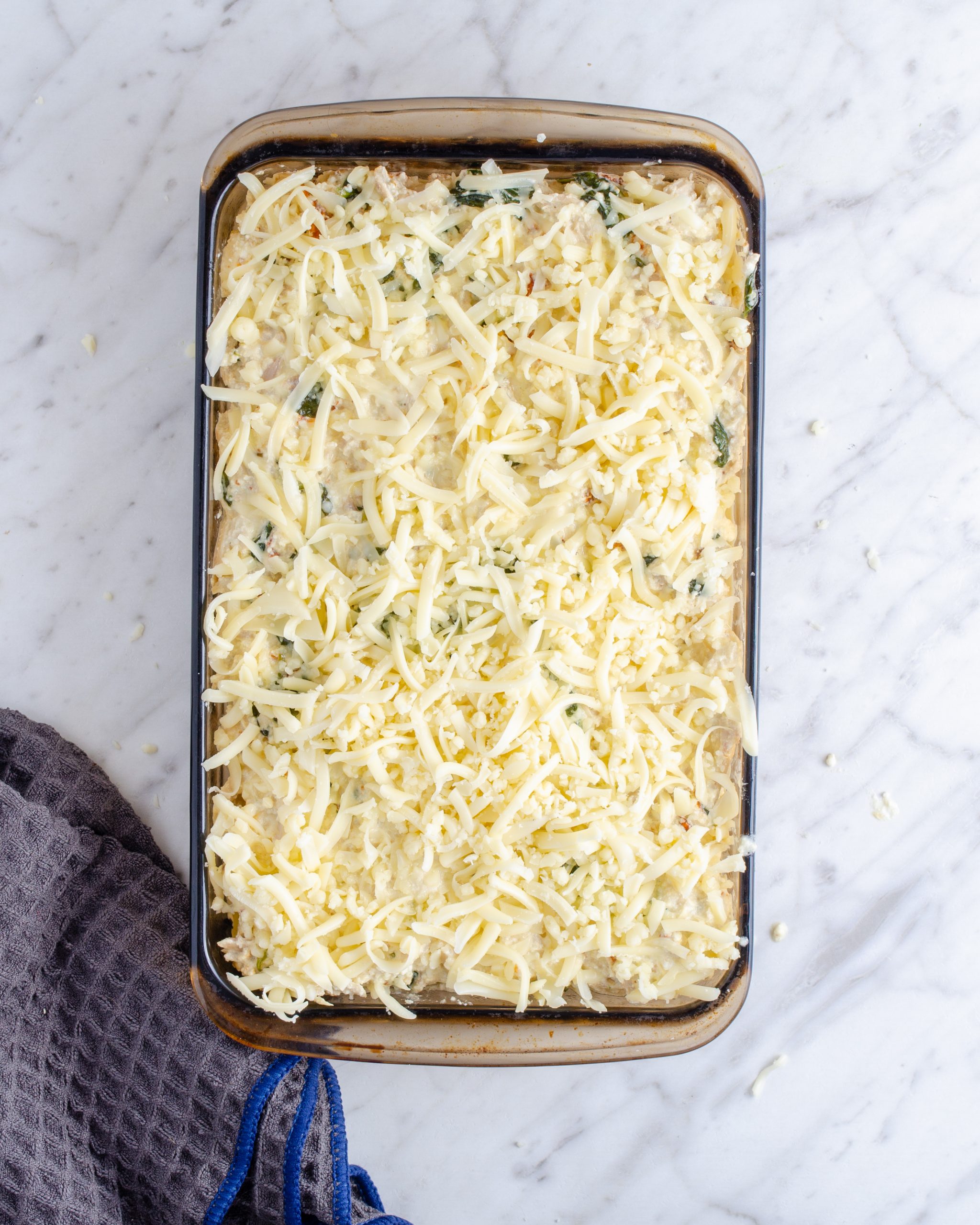 Repeat layers of noodles, sauce, and cheese until the ingredients are used up.