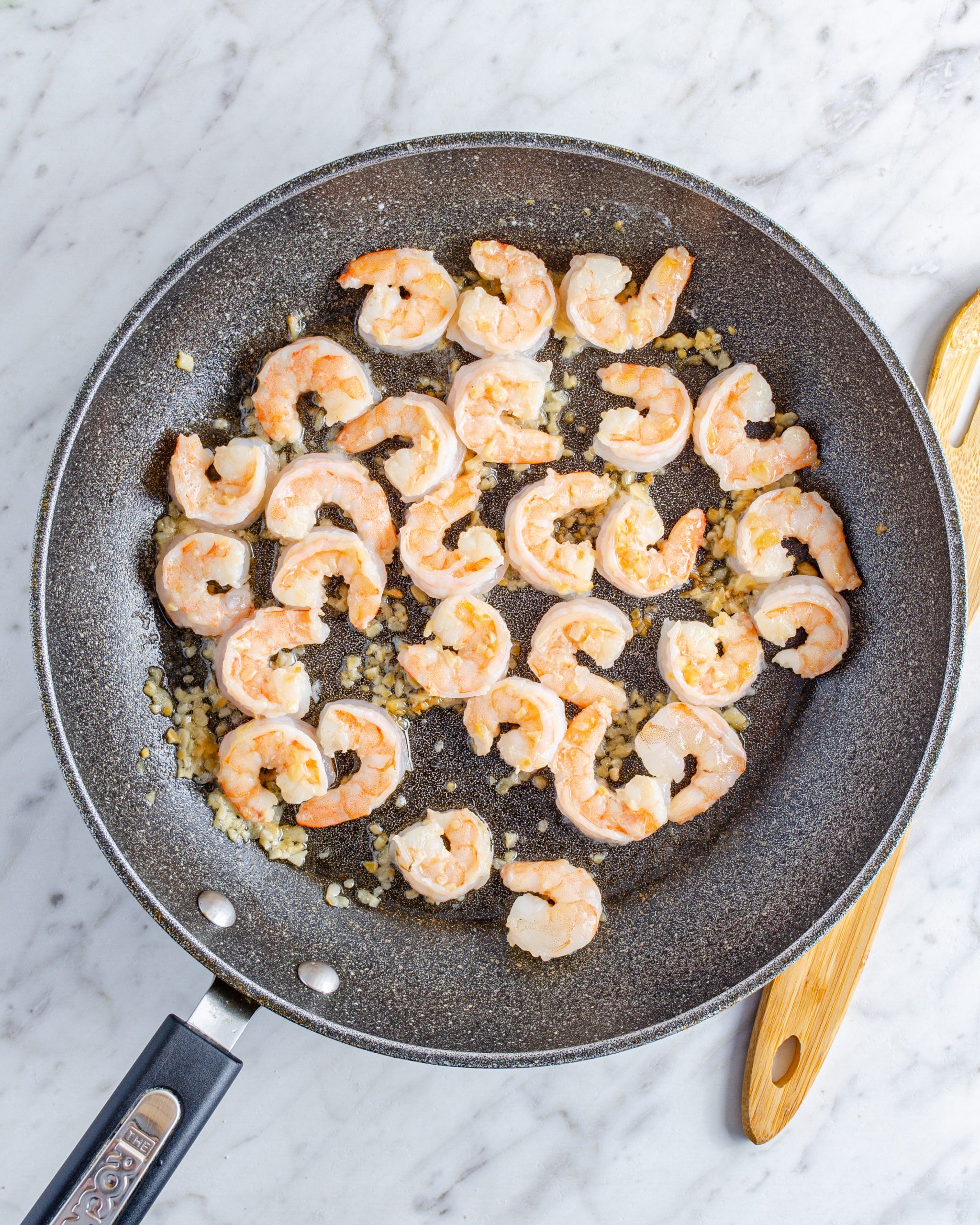 Add the shrimp to the skillet, and saute until cooked through. Season with salt and pepper to taste.