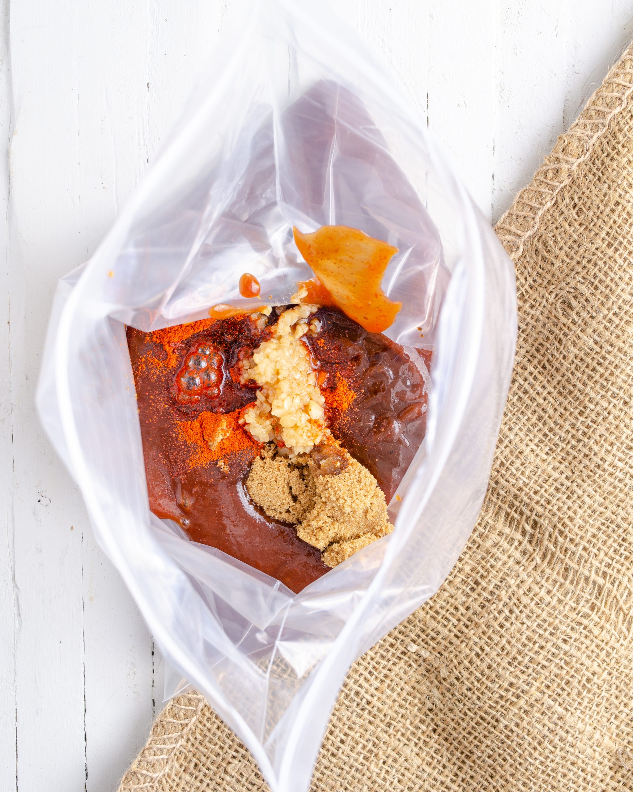 Place the BBQ sauce, Worcestershire sauce, minced garlic, cayenne pepper, and brown sugar into a large Ziploc bag. 