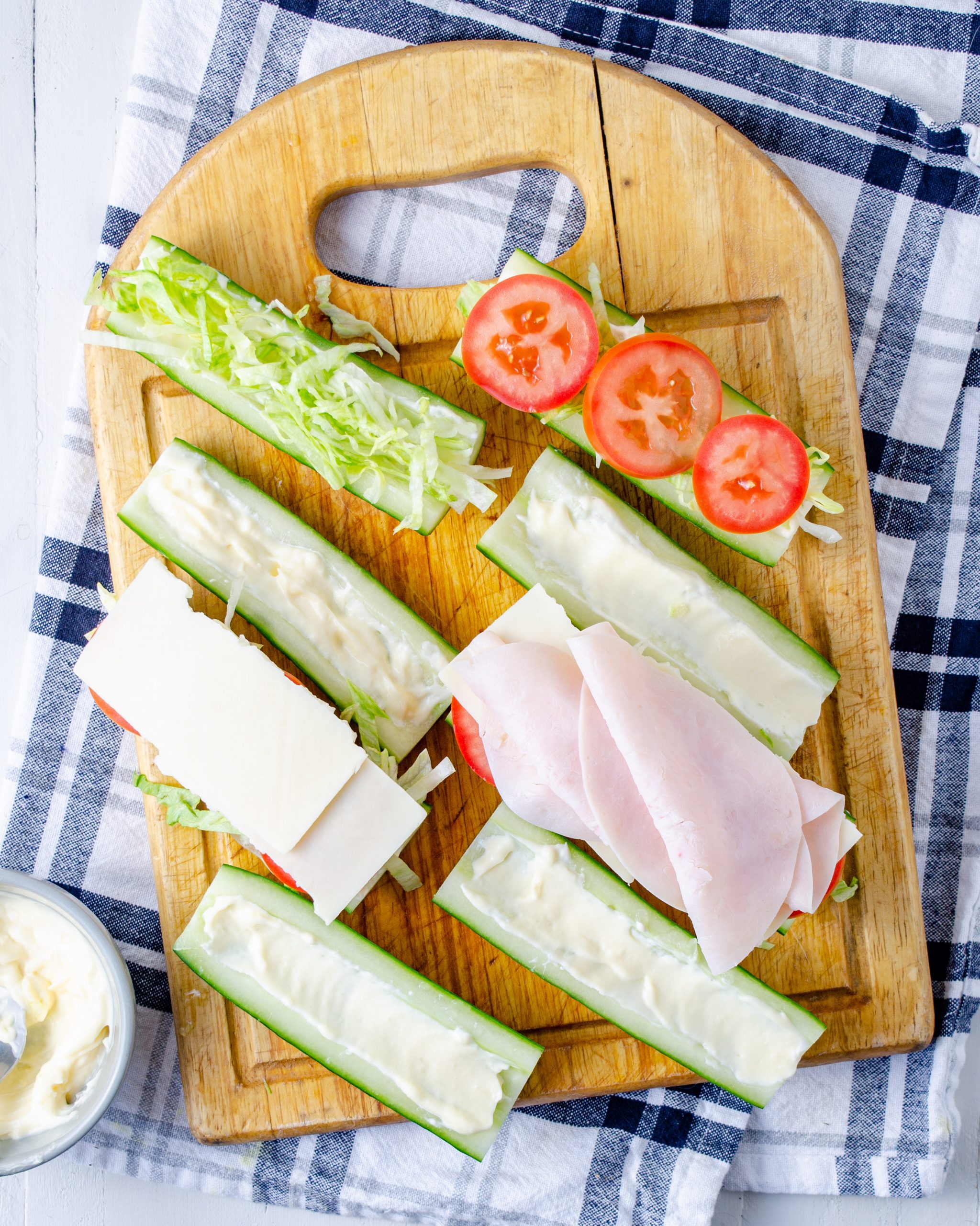 Top that half with tomatoes, lettuce, a slice of cheese cut in half, and ¼ of the lunch meat. 