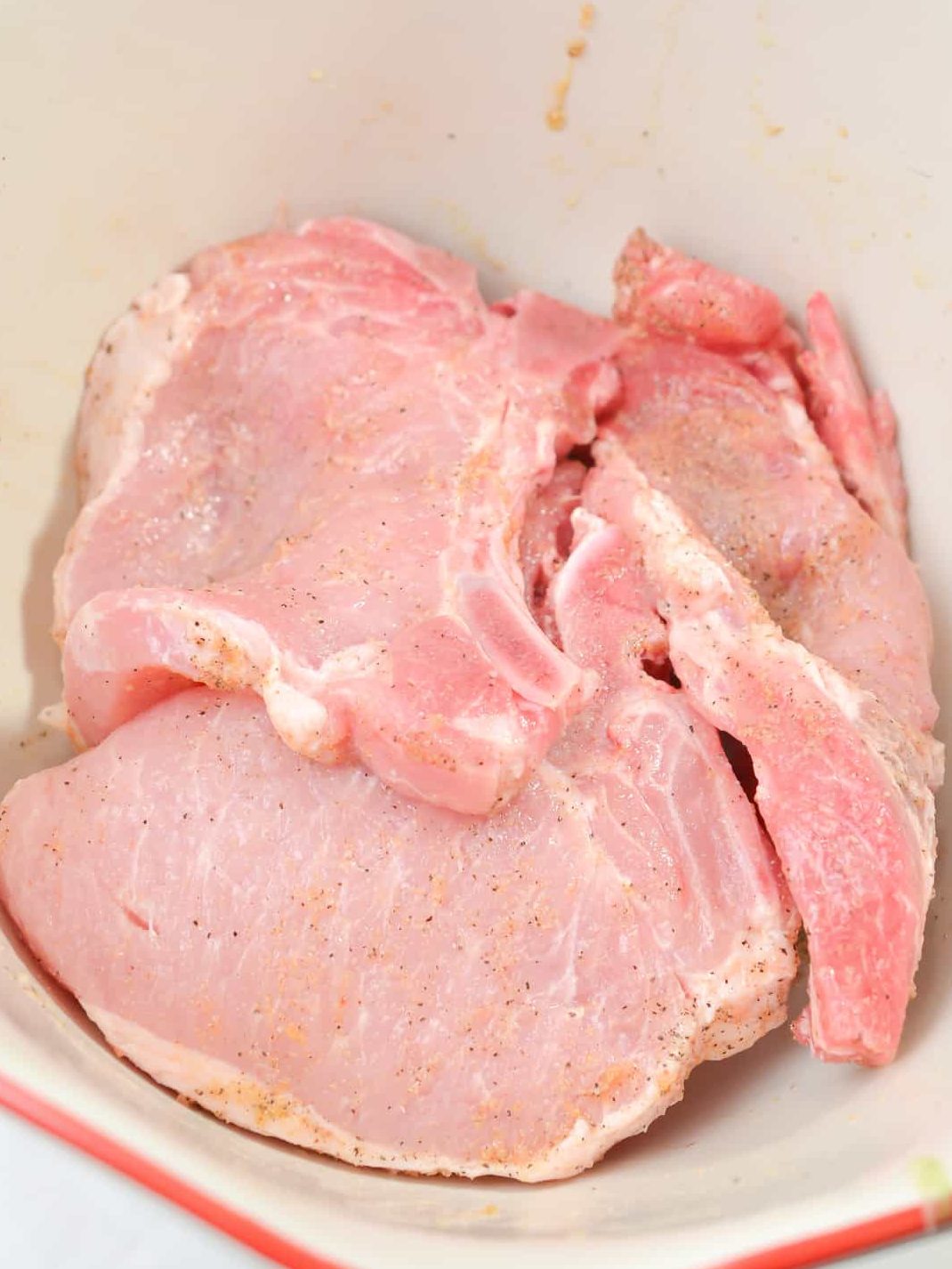 Place the pork chops in a bowl. Drizzle with olive oil, and coat in your choice of seasonings.