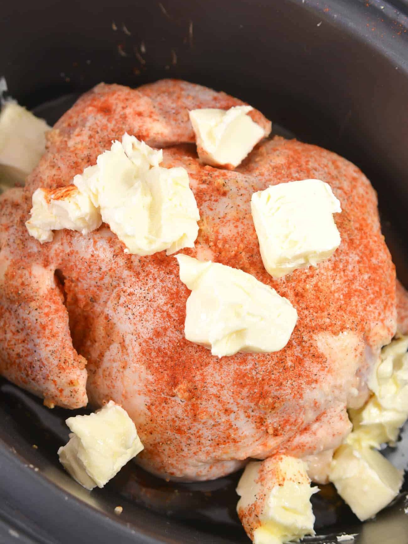 Add slices of the butter to the top of the chicken, and scatter the rest around the bottom of the chicken in the Crockpot. Cook on low for 6-8 hours.