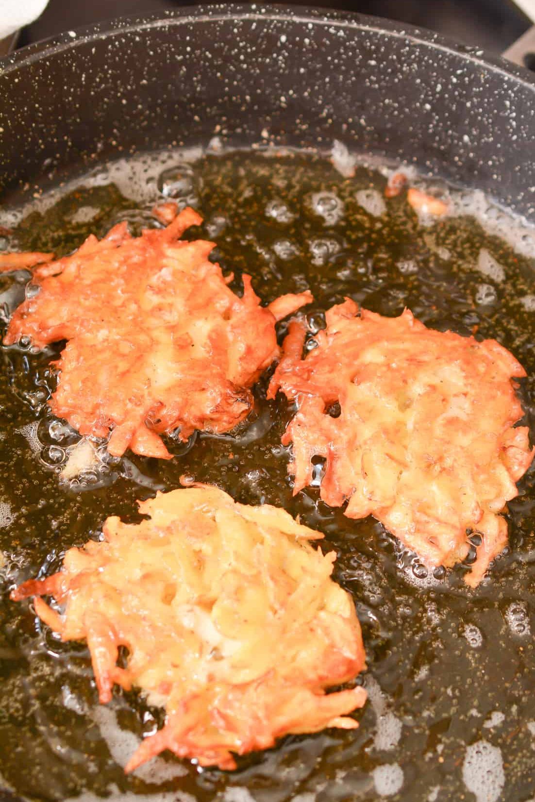 Add the potato mixture in small ¼ cup pancake shapes to the heated oil, and cook for a few minutes on each side until golden brown and crispy.