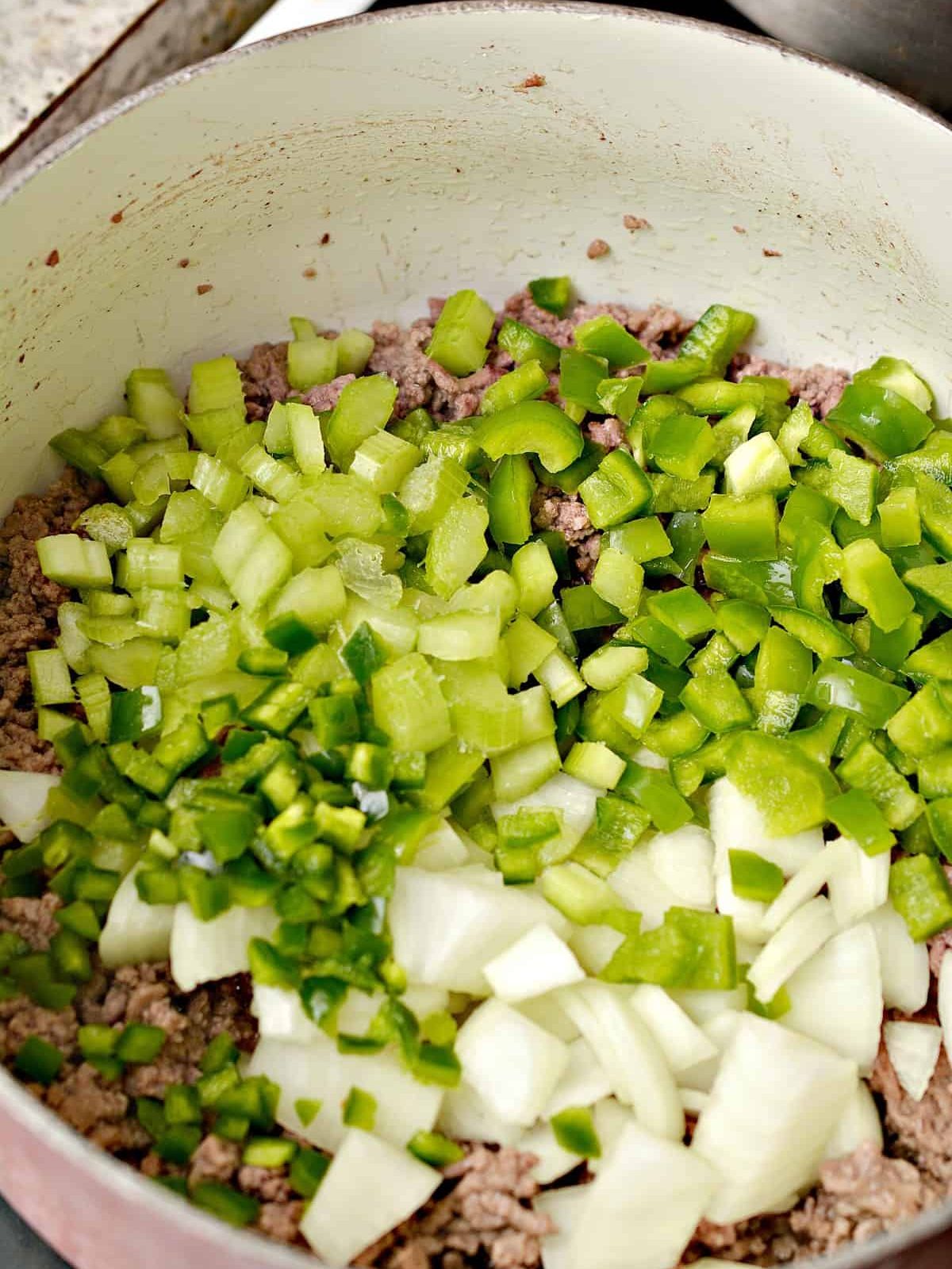 Add 1 bell pepper chopped, 1 onion chopped, and ⅓ cup of celery chopped to the pot.