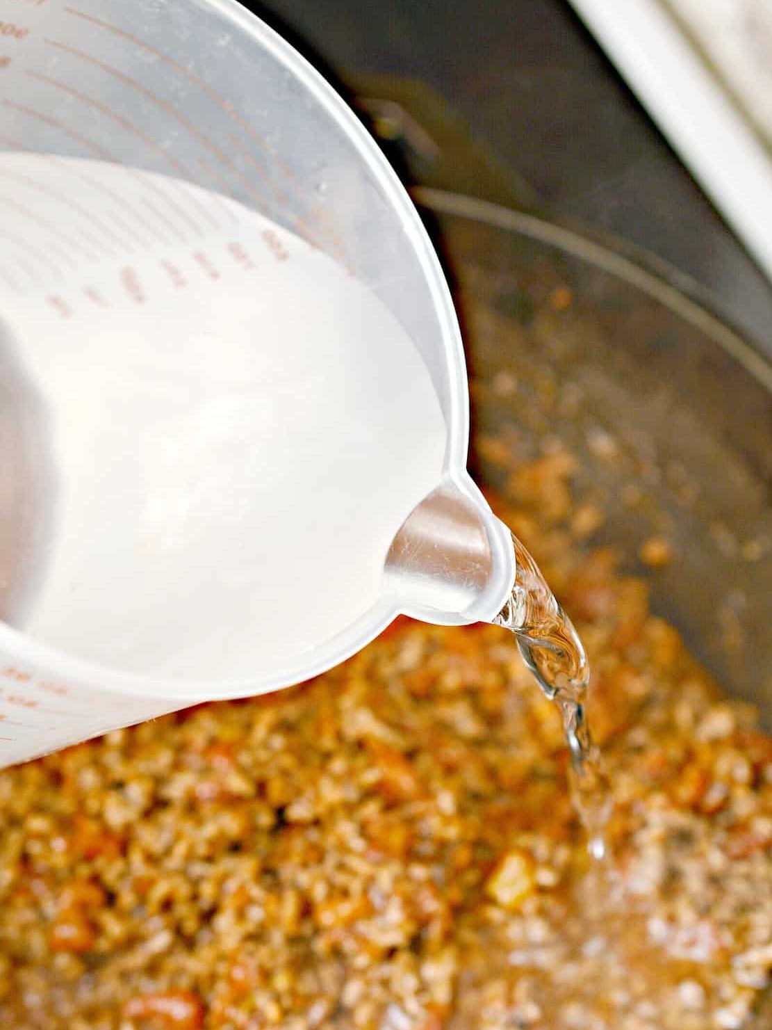 Pour 3 cups of water into the skillet.