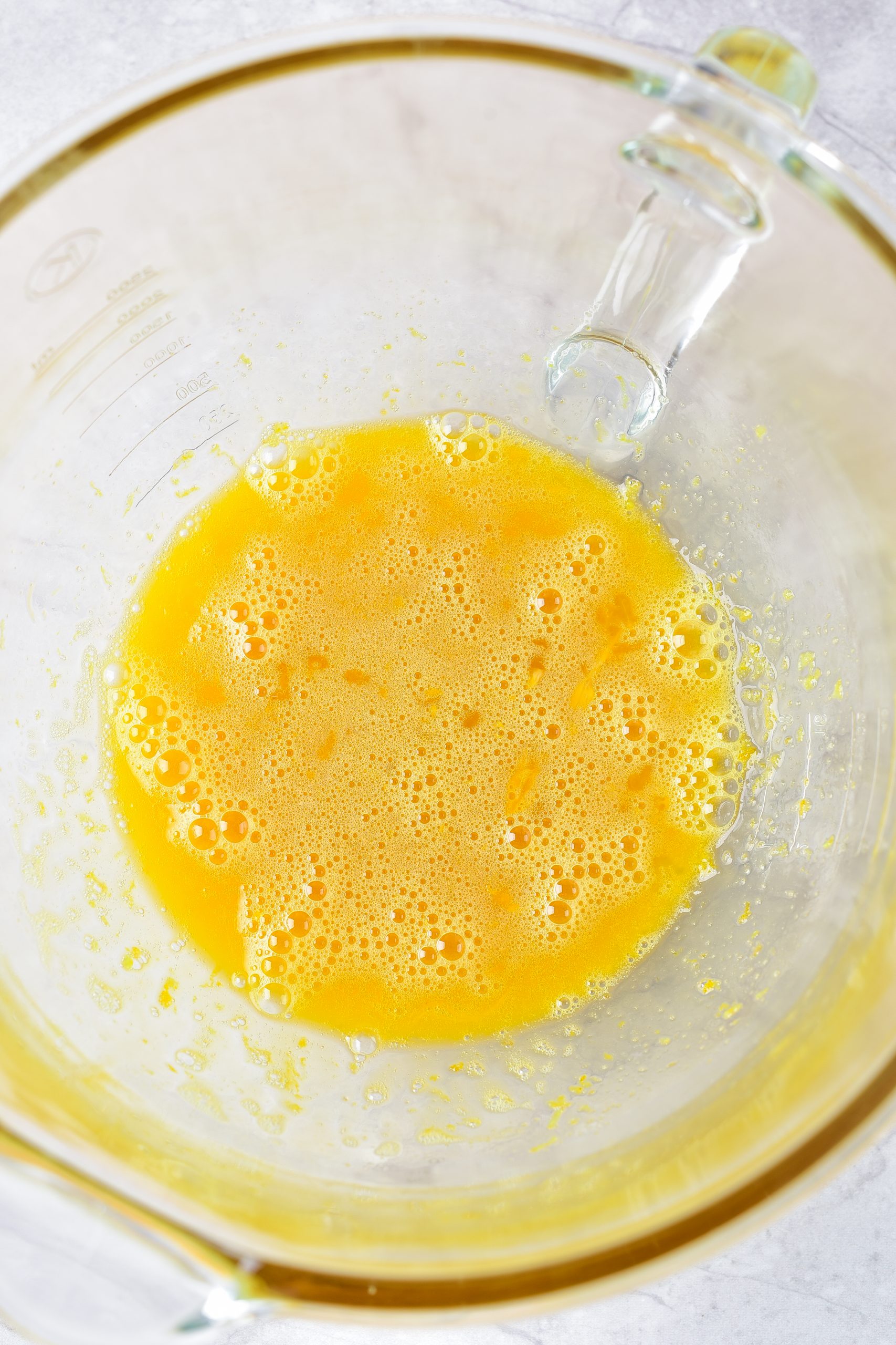 Blend together the eggs, lemon extract, and lemon zest in a separate bowl. 