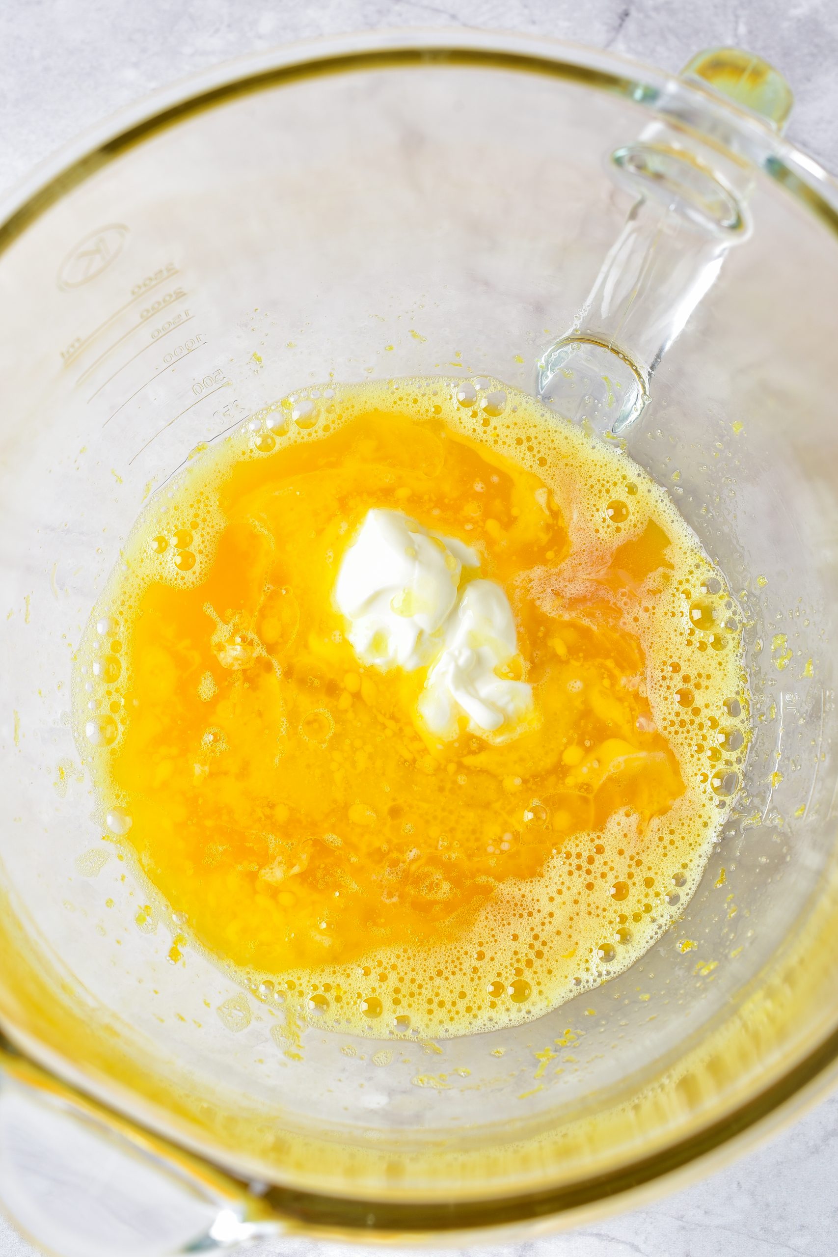 Mix the butter, sour cream, and vanilla into the bowl with the egg mixture, and blend until smooth. 