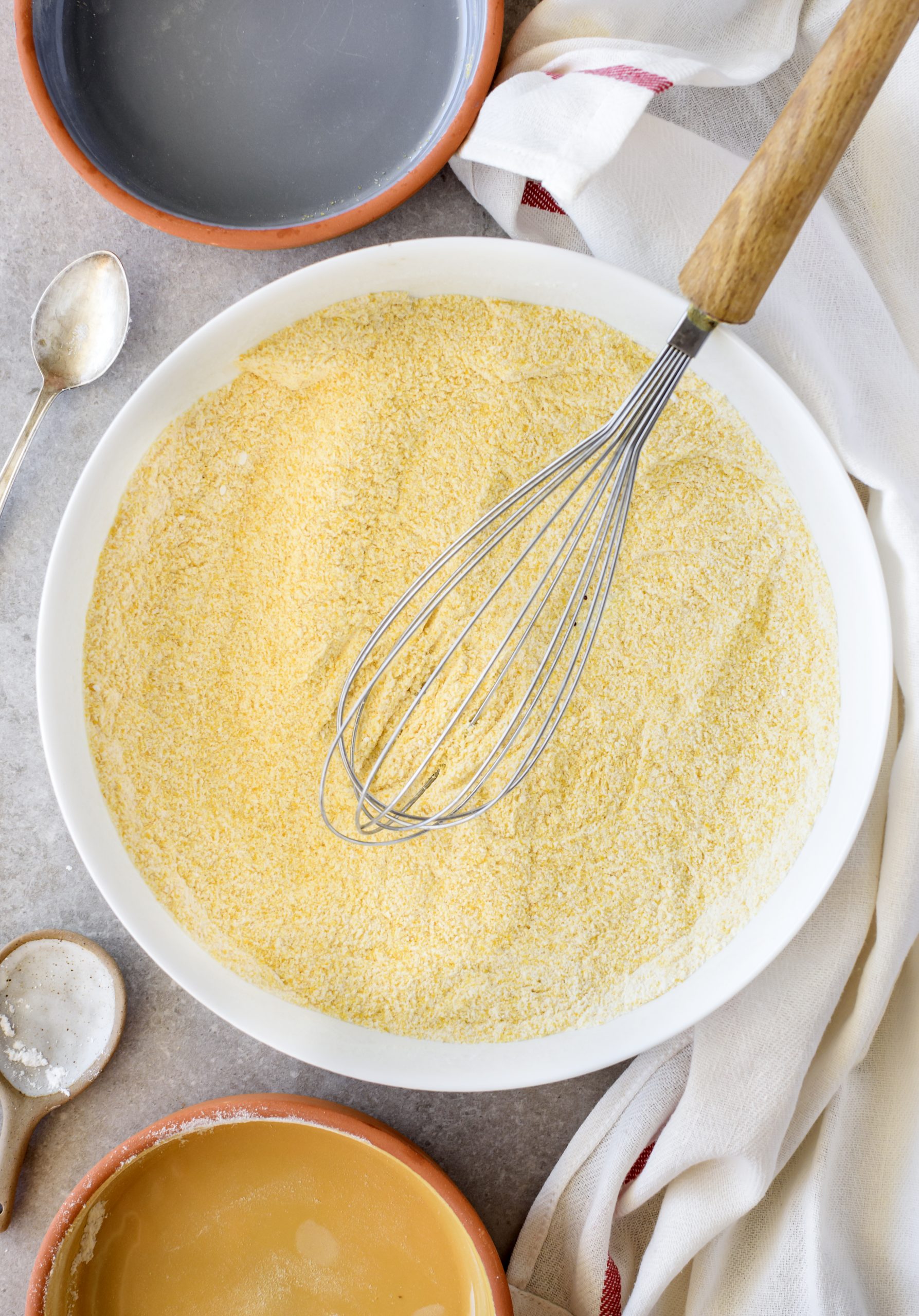 Mix together the sugar, flour, salt, baking powder, and cornmeal in a large bowl. 