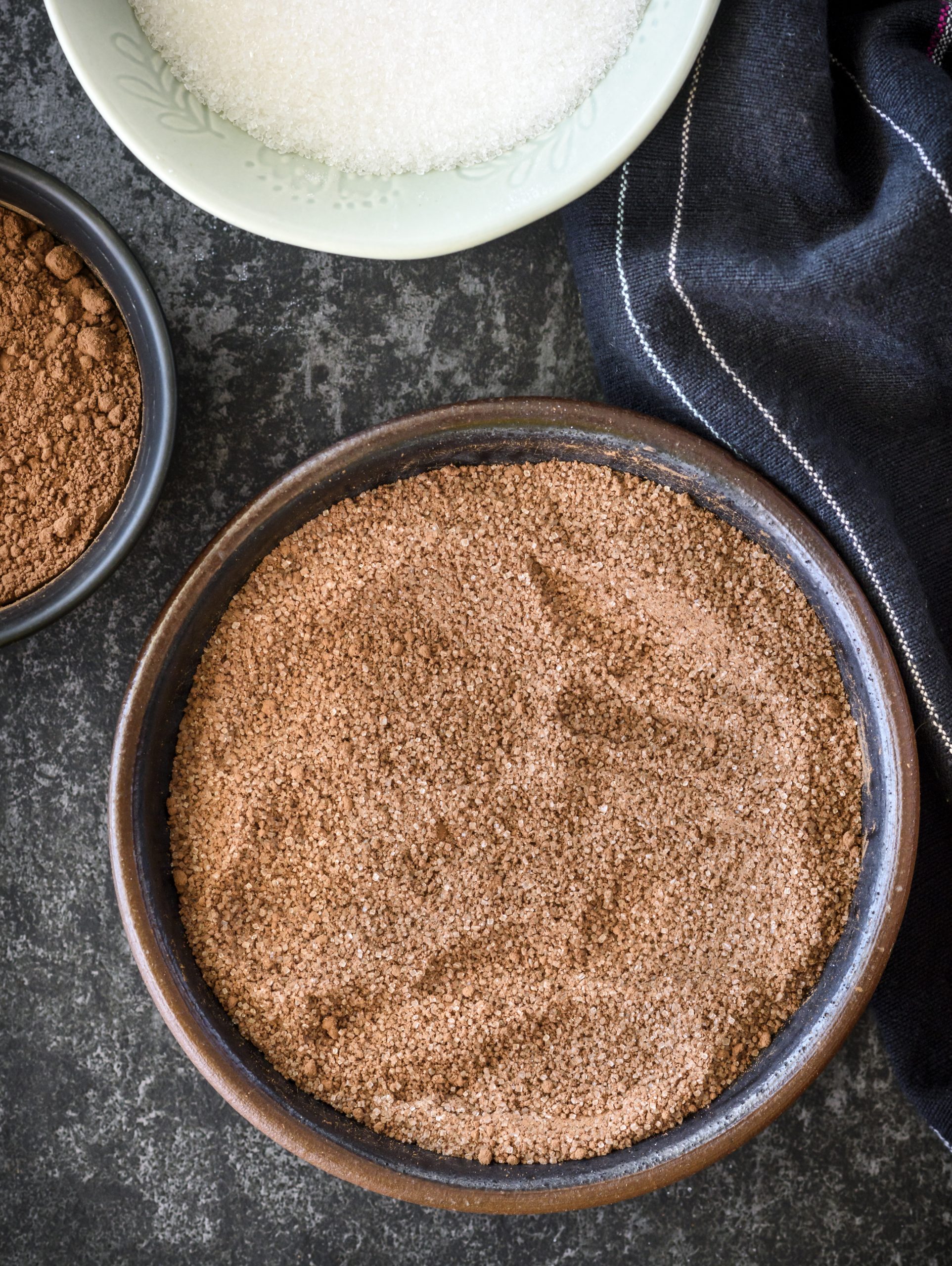 In a mixing bowl, stir together the flour, ¼ cup of the cocoa powder, and ½ cup of the sugar. 