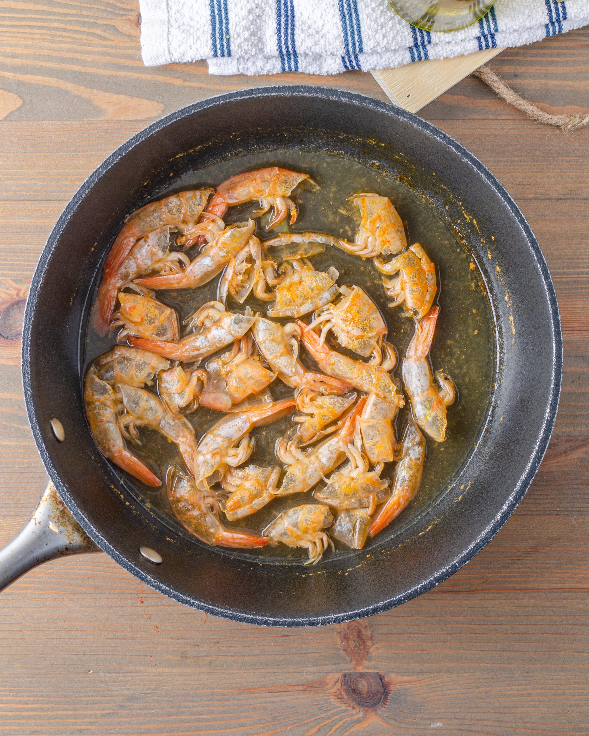 Place the shells from the shrimp into a pot of boiling water. Simmer the shells for 20 minutes, then remove them from the pot. 