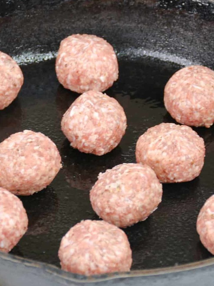 Add one meatball at a time to the heated skillet.